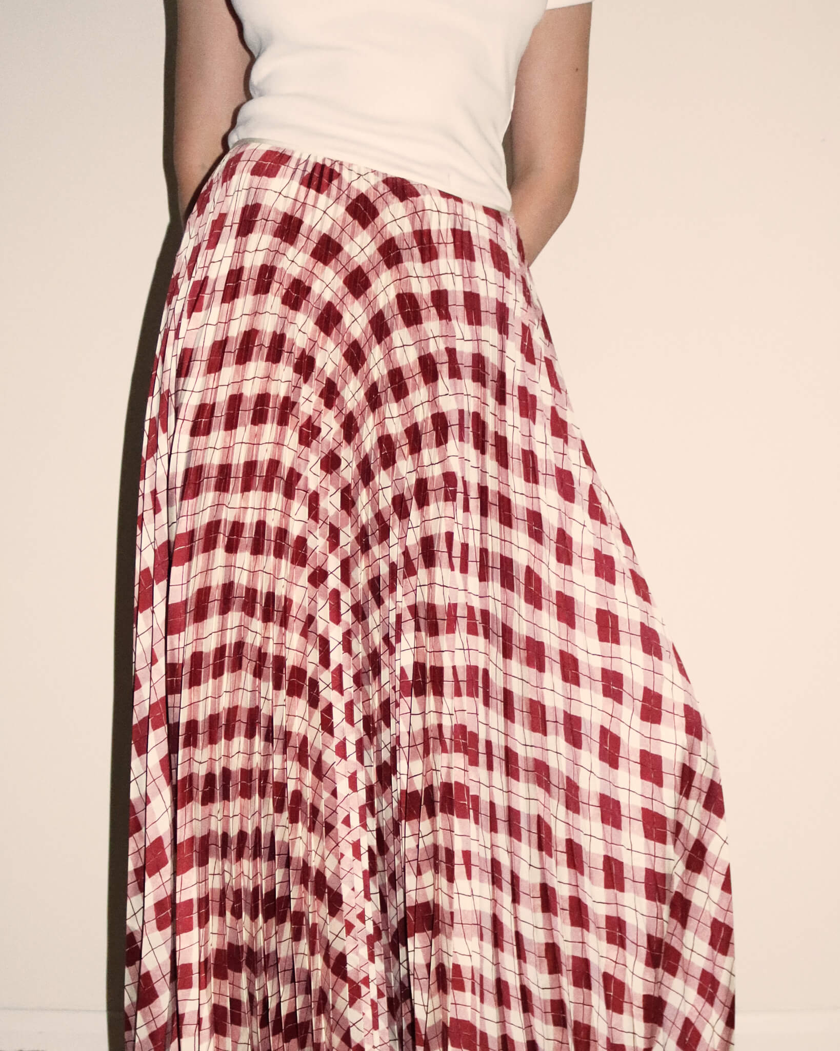 Close-up image of 'Kate' Checked Maxi Pleated Skirt in pink and burgundy.