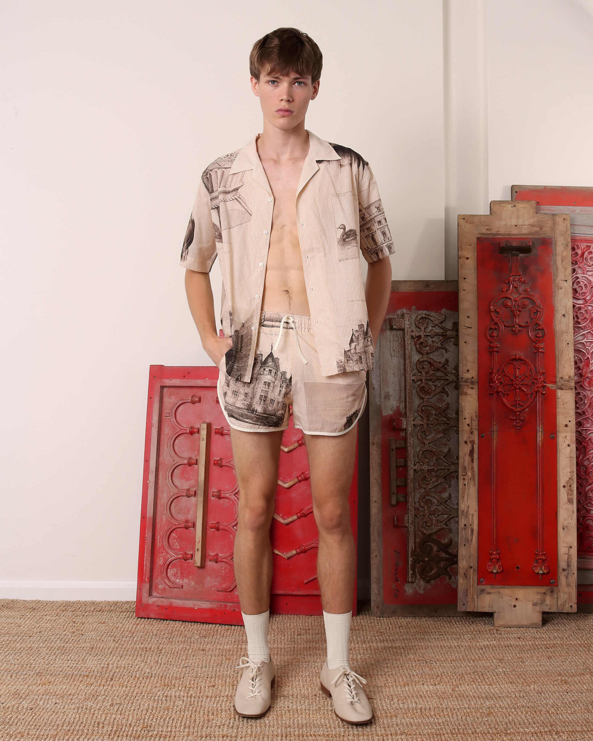 A model wears the 'Estate Sale' Shirt unbuttoned with the matching 'Estate Sale' drawstring shorts.