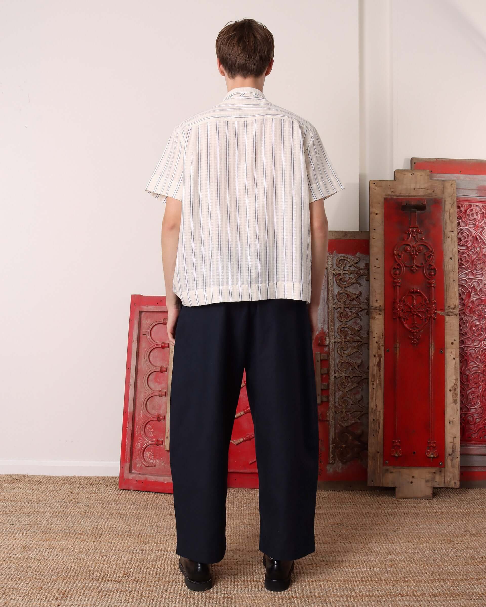 A model shows the back of the striped 'Turing' Shirt with short sleeves.