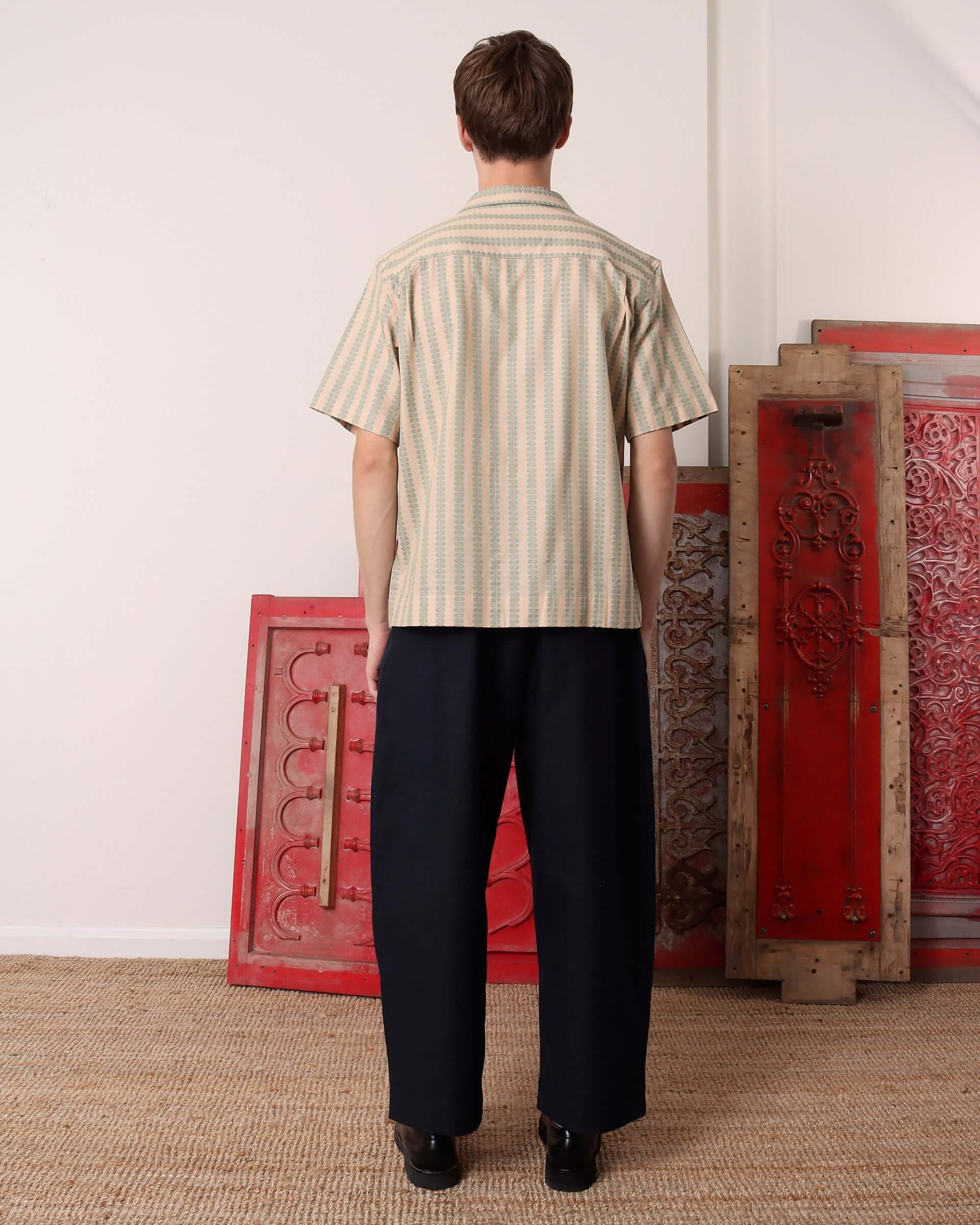 A model shows the back of the 'Arte' Short Sleeve Shirt.