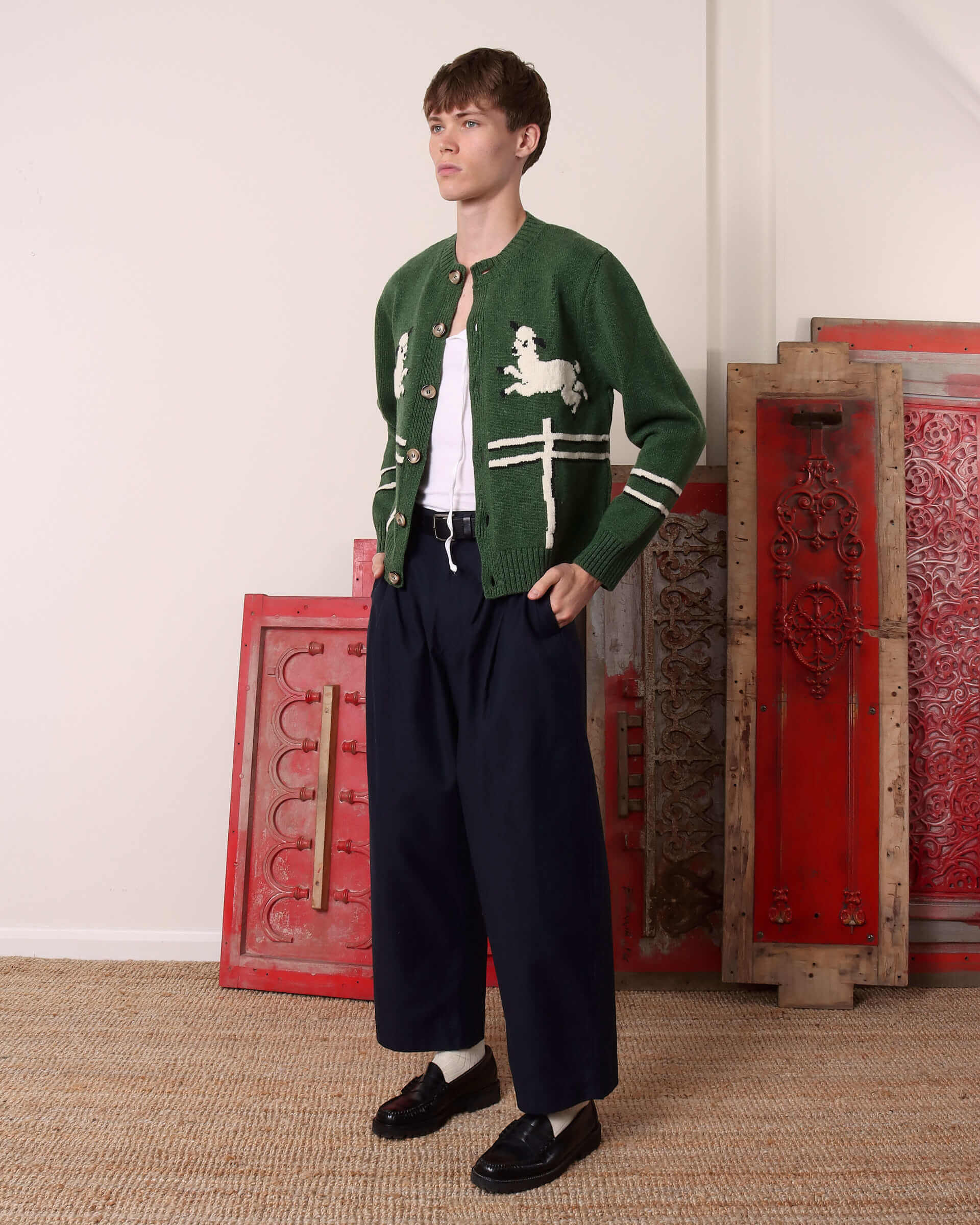 A model shows the side of the unbuttoned 'Cyril' Lamb Motif Cardigan in green.