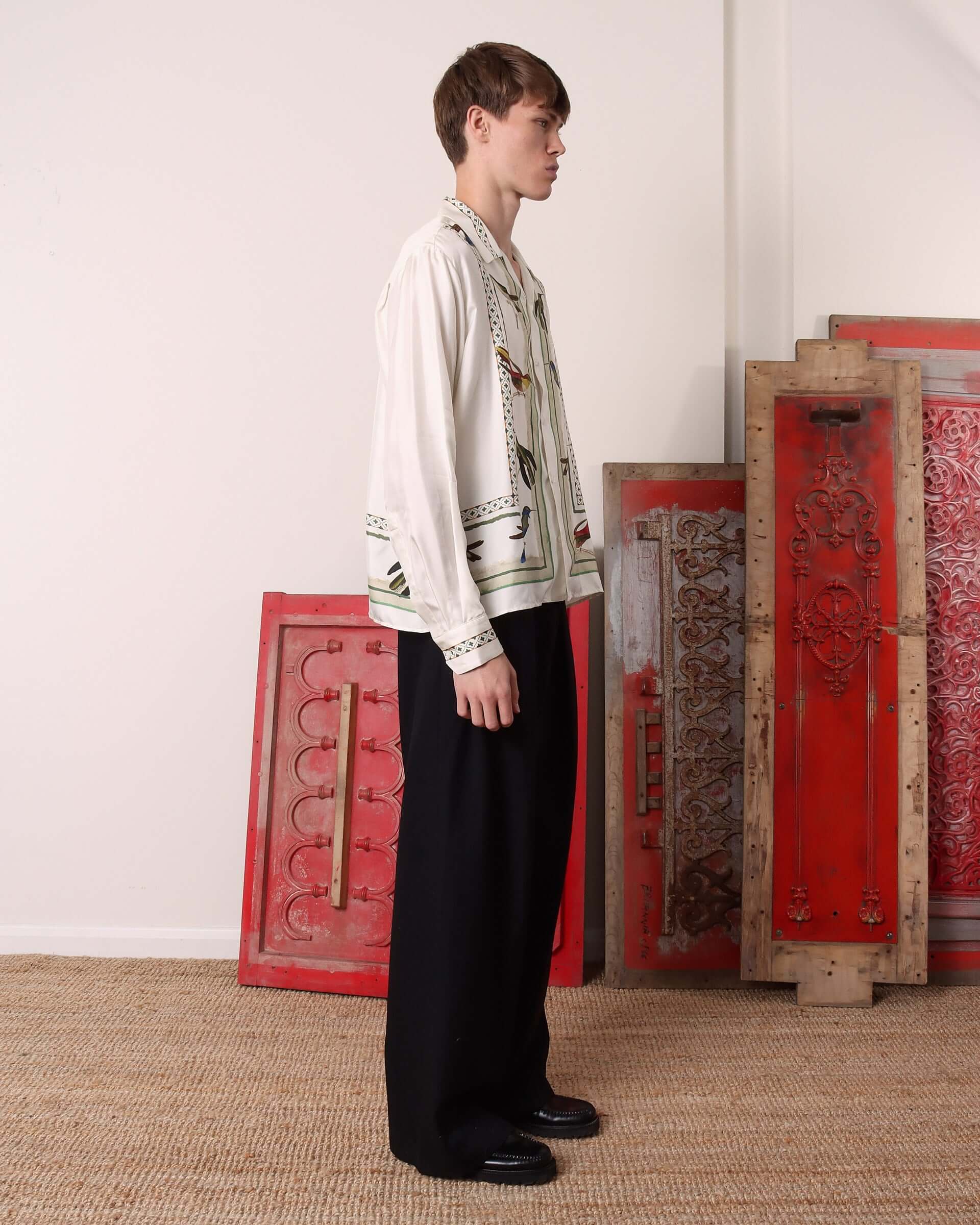 A model shows the side of the long sleeve 'Birdwatcher' Shirt.
