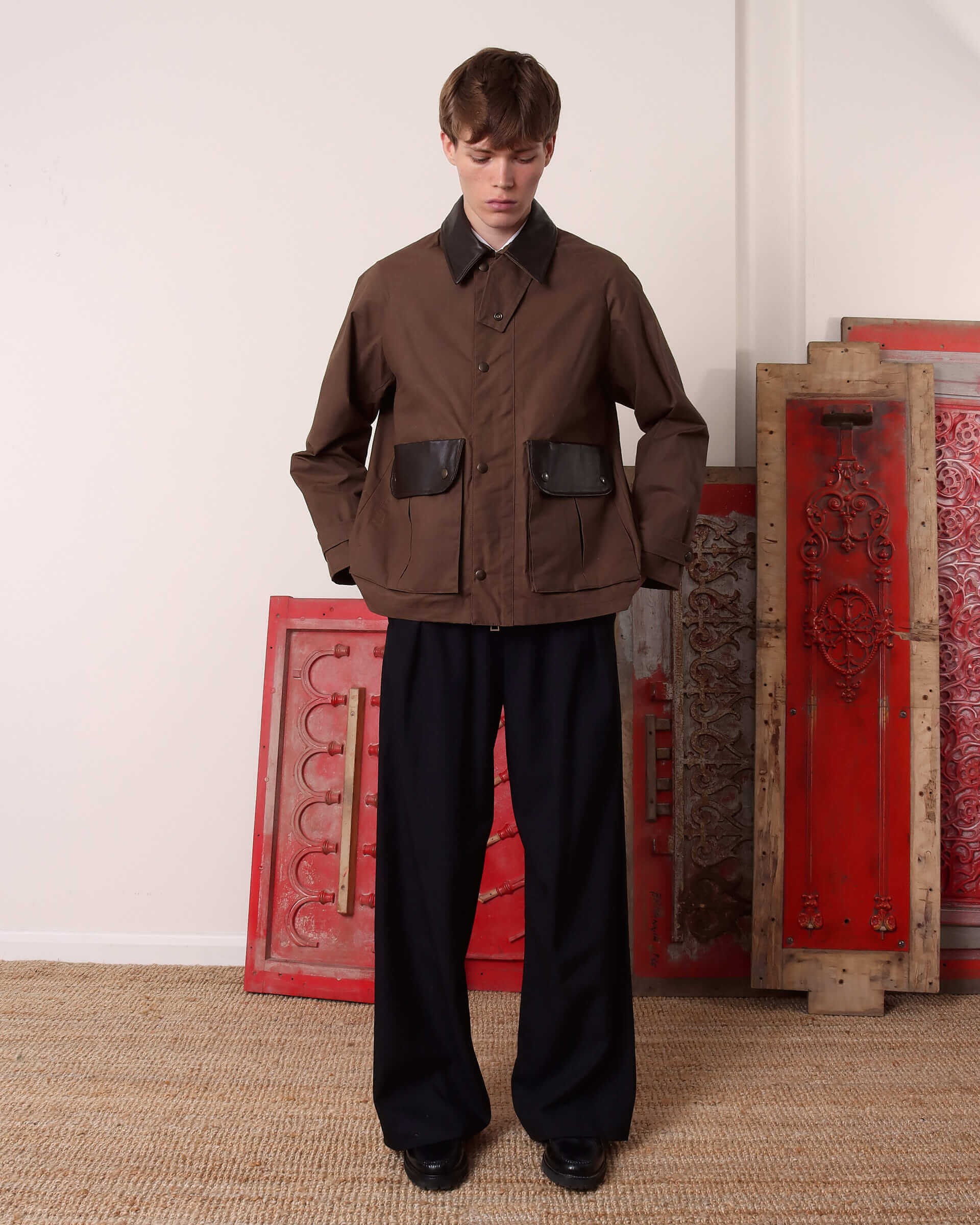 A model wears the 'Theodore' Waxed Blouson buttoned up to the collar.