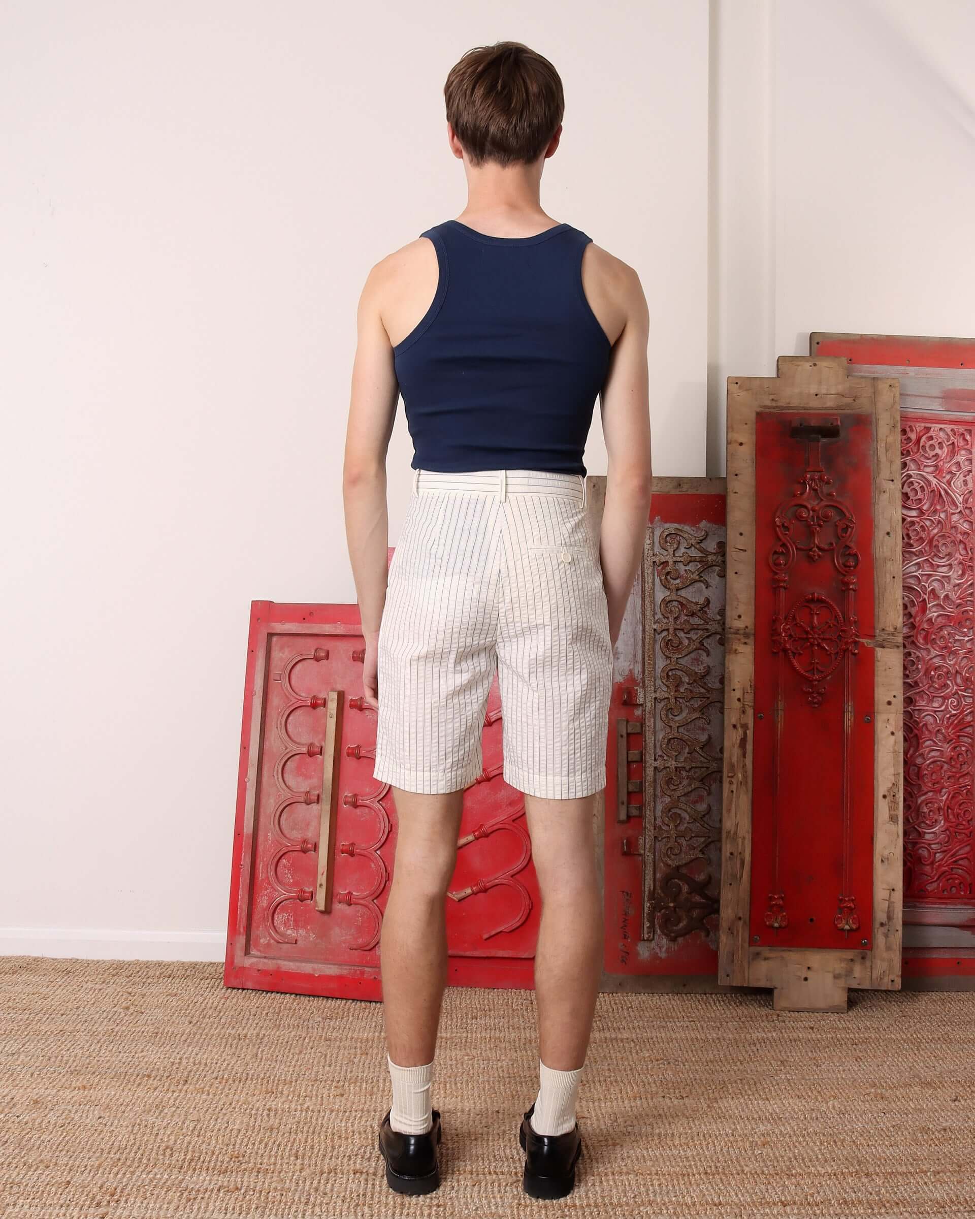 A model shows the back of the 'Clement' Shorts. 