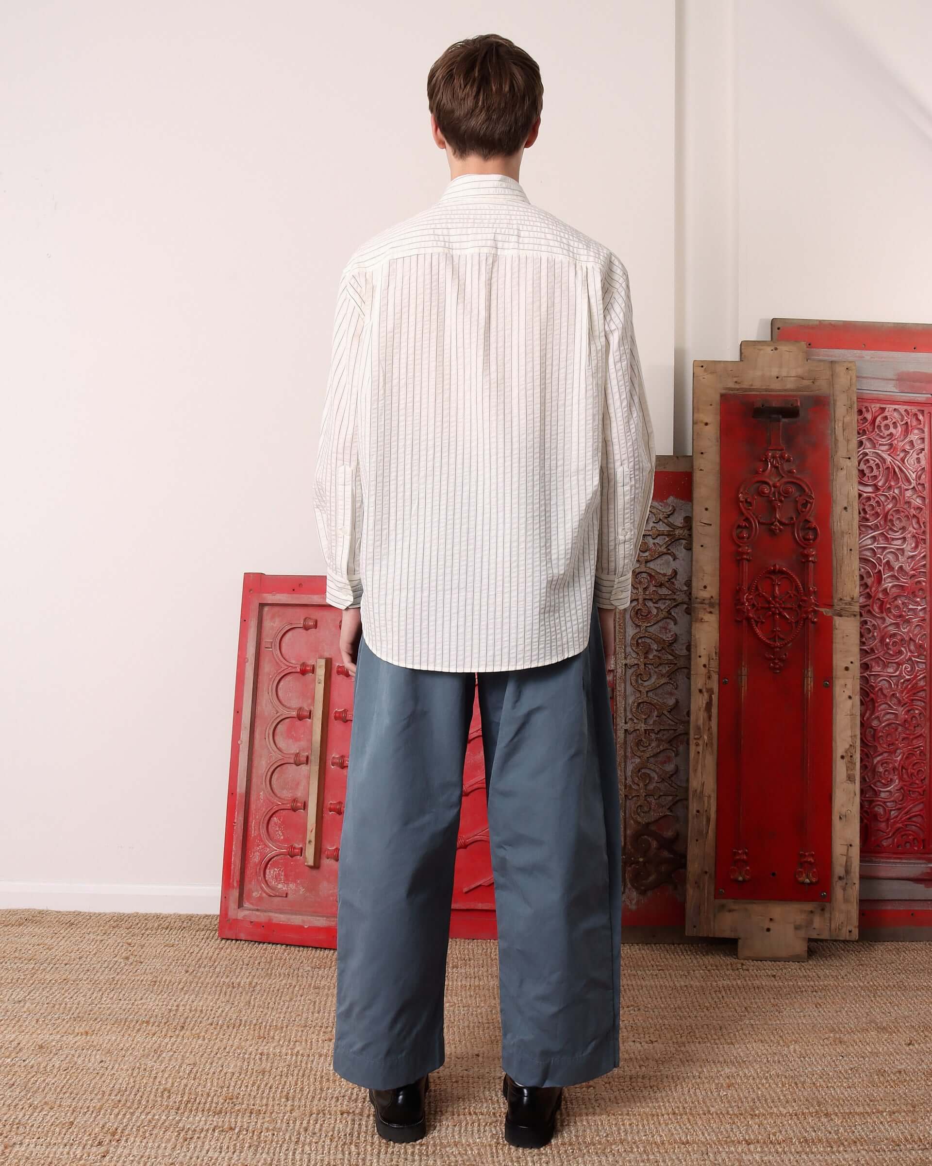 A model shows the back of the 'Cuthbert' Shirt and blue jeans.
