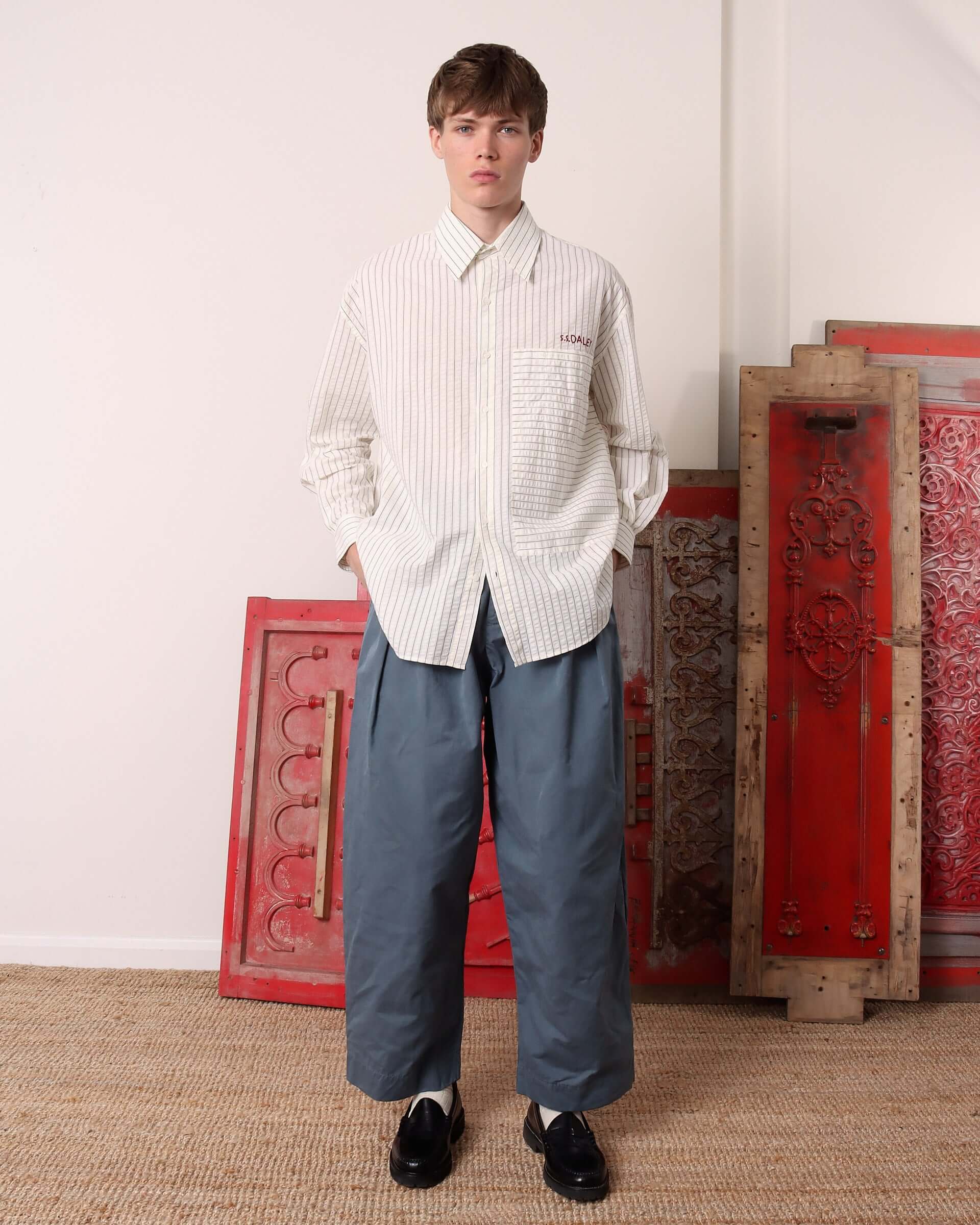 A model poses in the striped 'Cuthbert' Shirt and blue jeans.