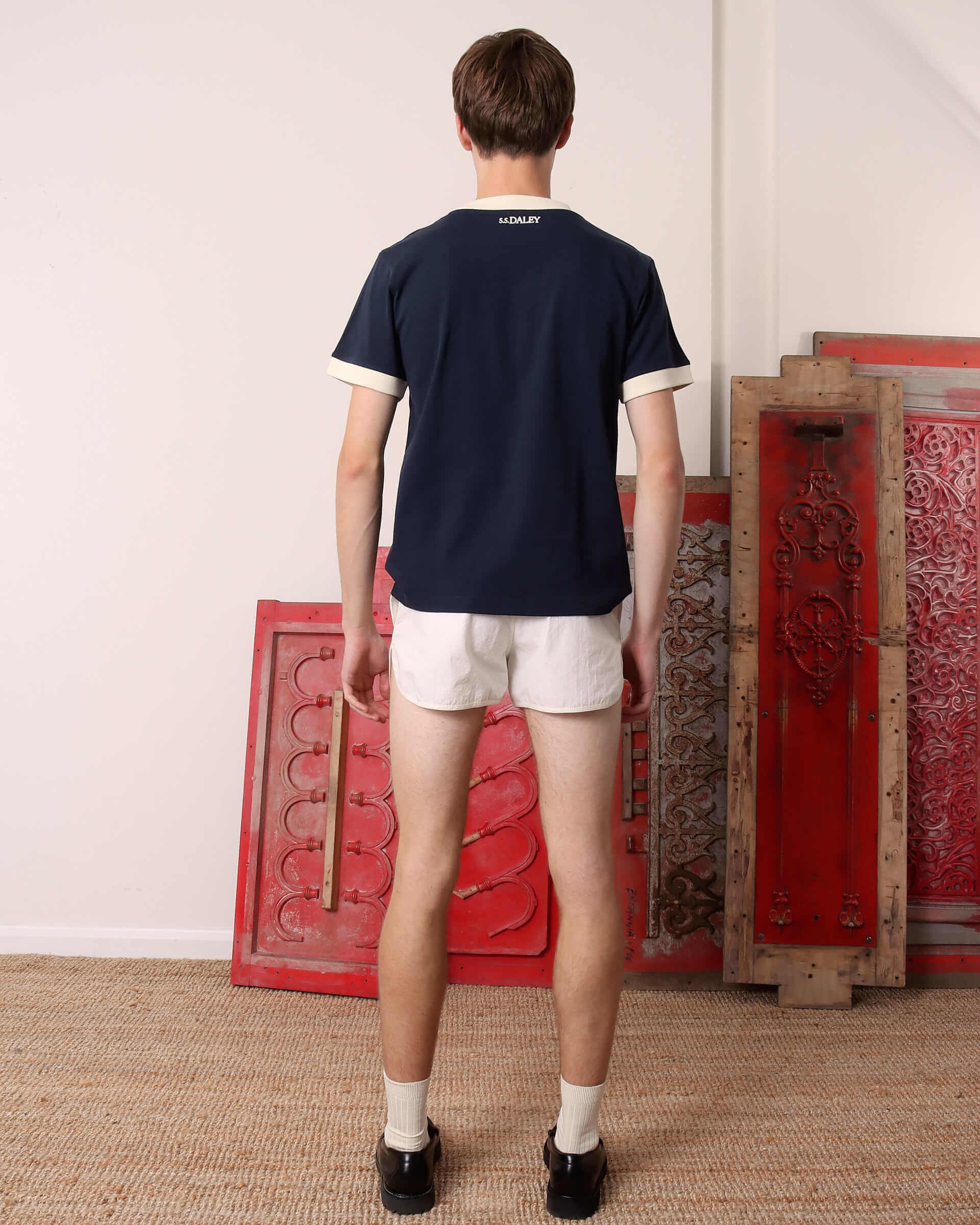 A model shows the back of the 'Tap' T-Shirt in Navy.