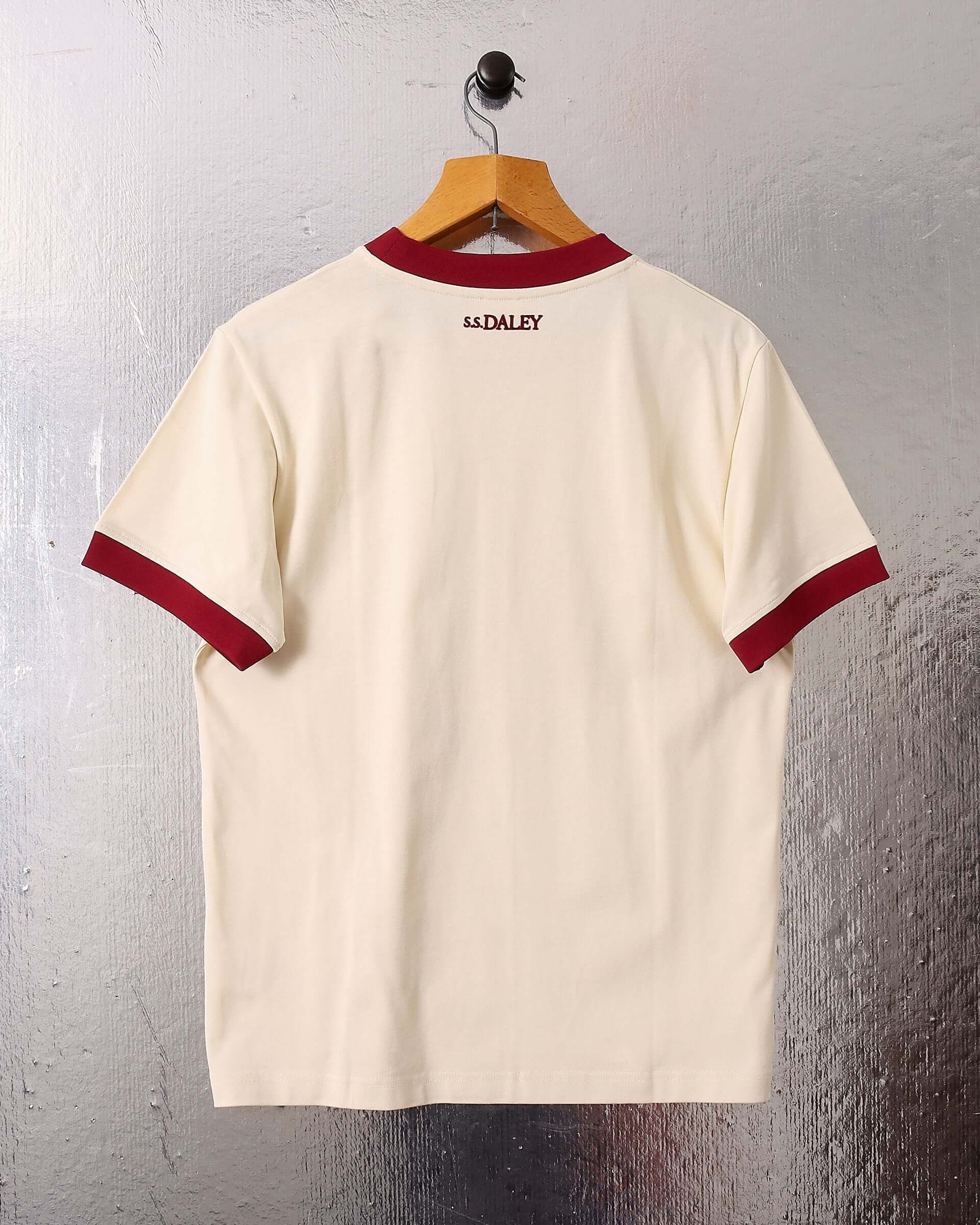 A flat shot of the 'Tap' T-shirt on a hanger showing the back of the garment and the boxy fit, as well as the small burgundy S.S.DALEY logo at the top below the neckline. 