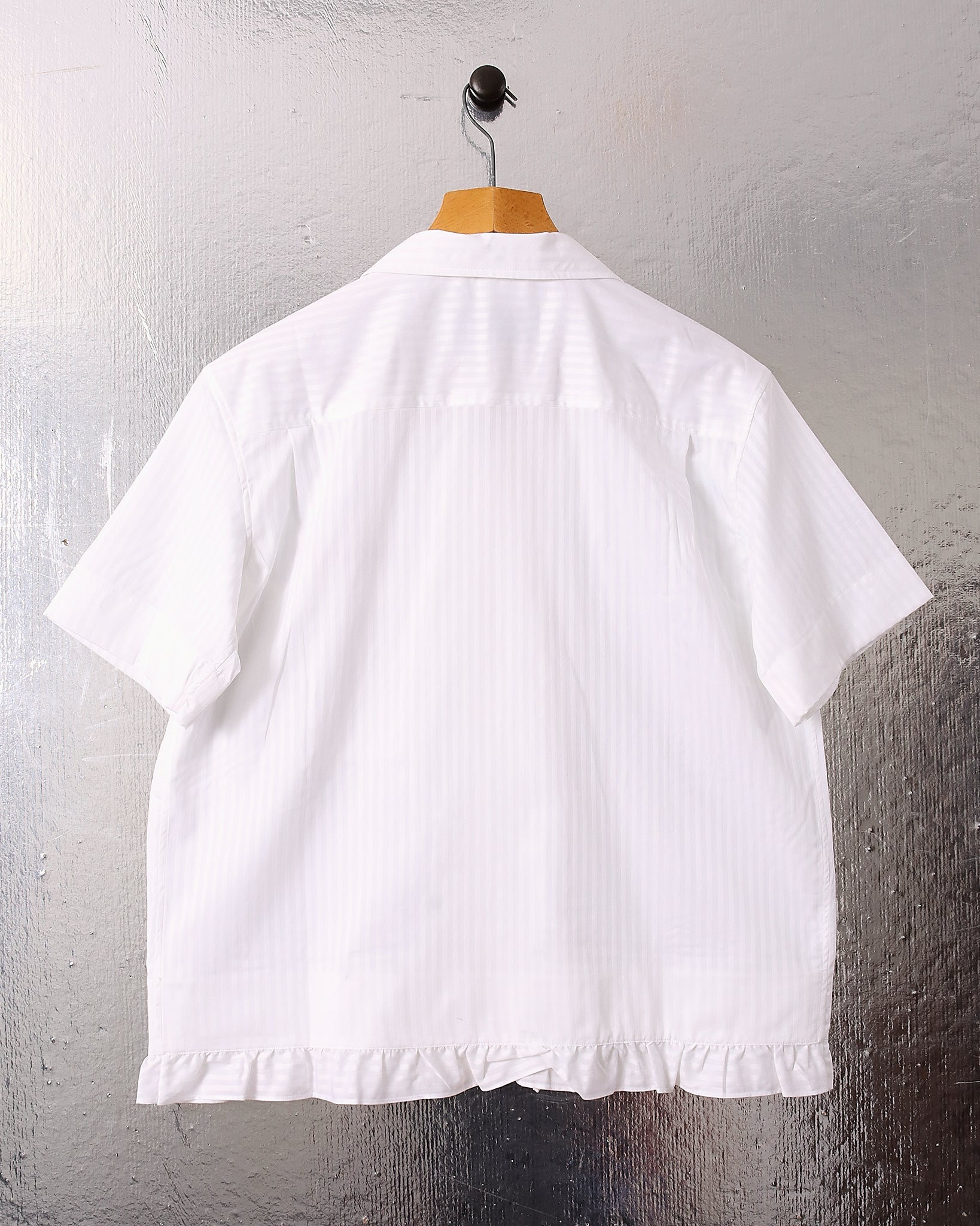 A flat shot of the back of the he 'Oxford' Striped Pillowcase Shirt in white stripes.