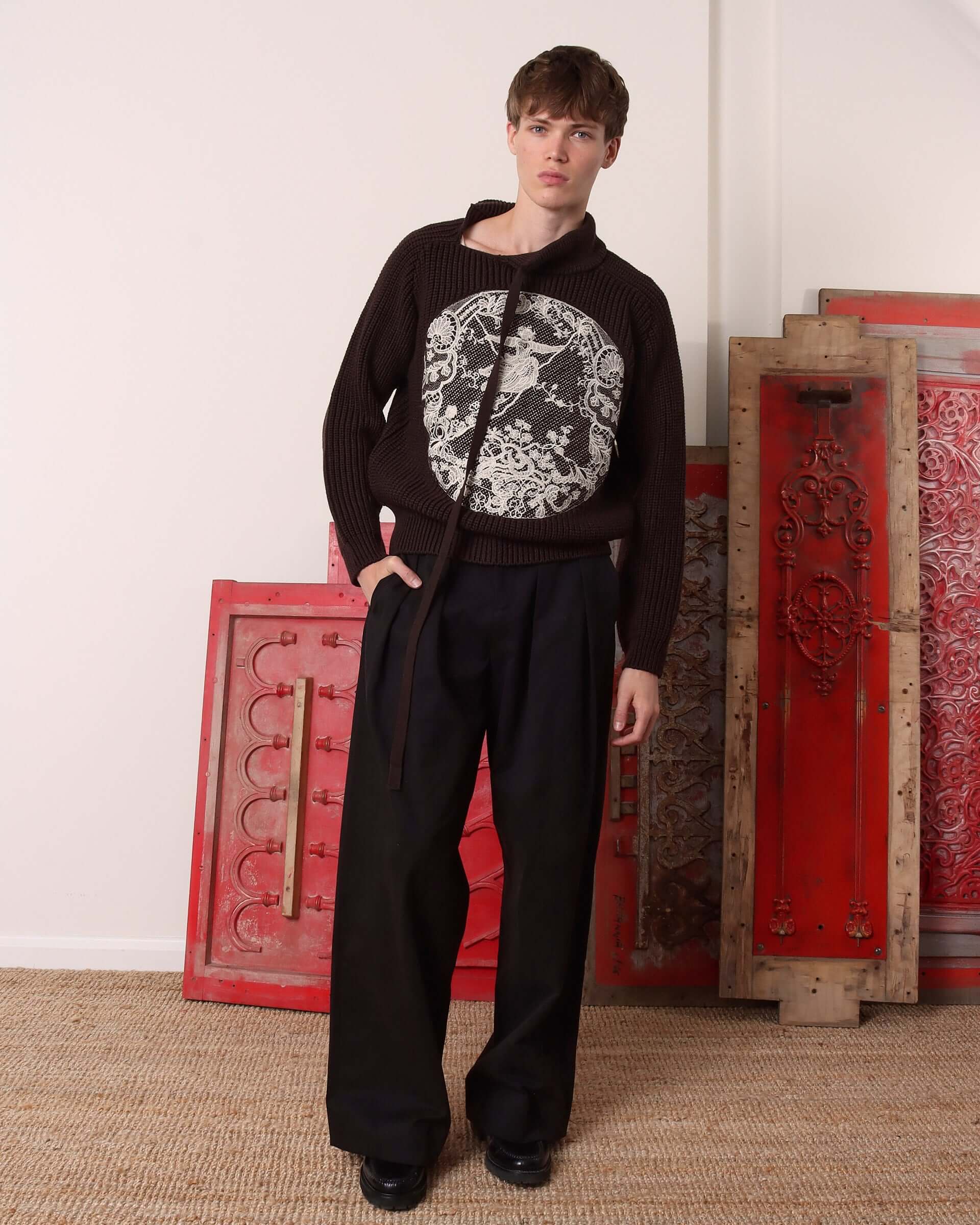 A model wears the 'Circle' Sweater with the asymmetric tie neckline untied. 