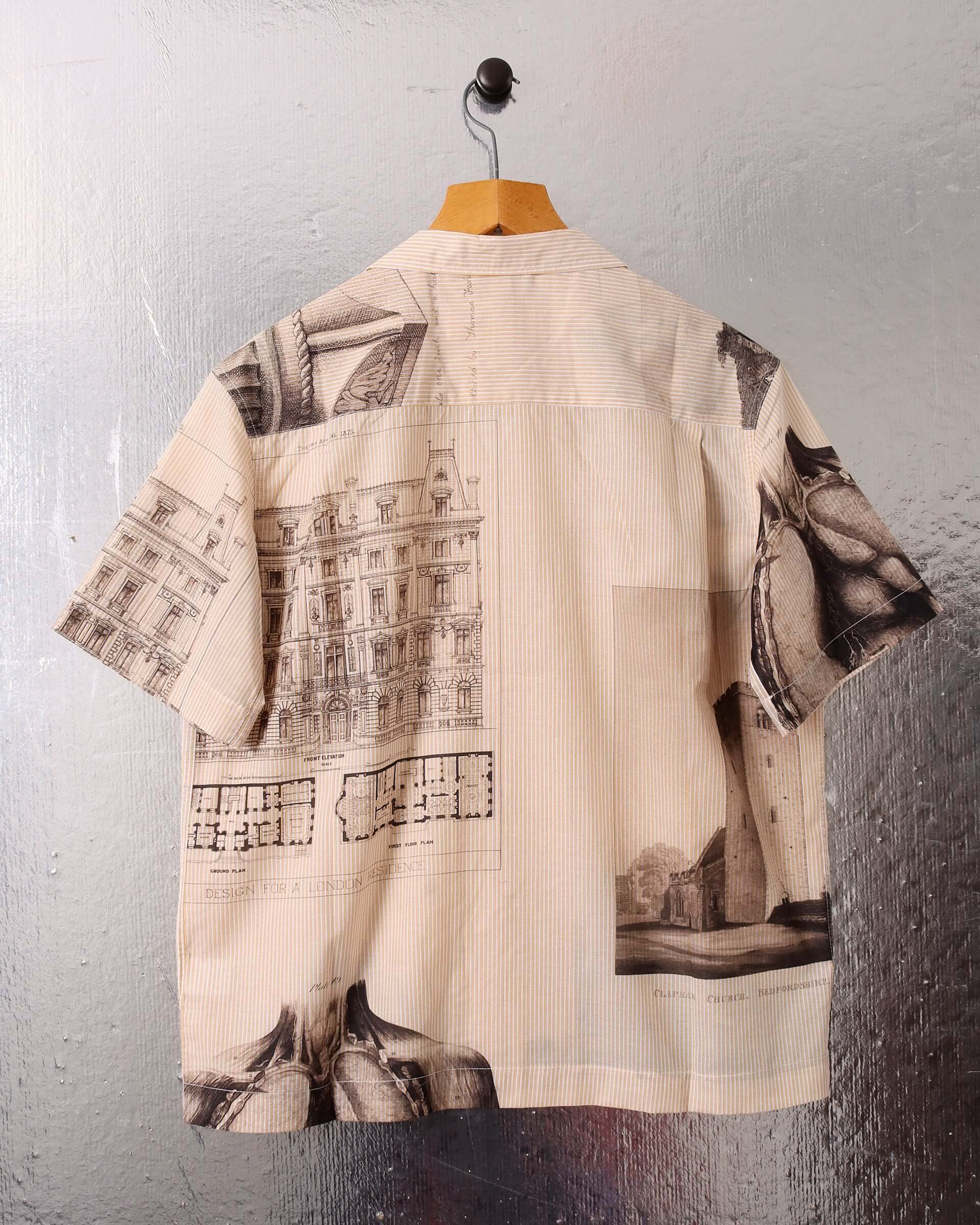 A flat image of the short sleeve 'Estate Sale' shirt showing the designs allover archival prints and back of the camp collar.