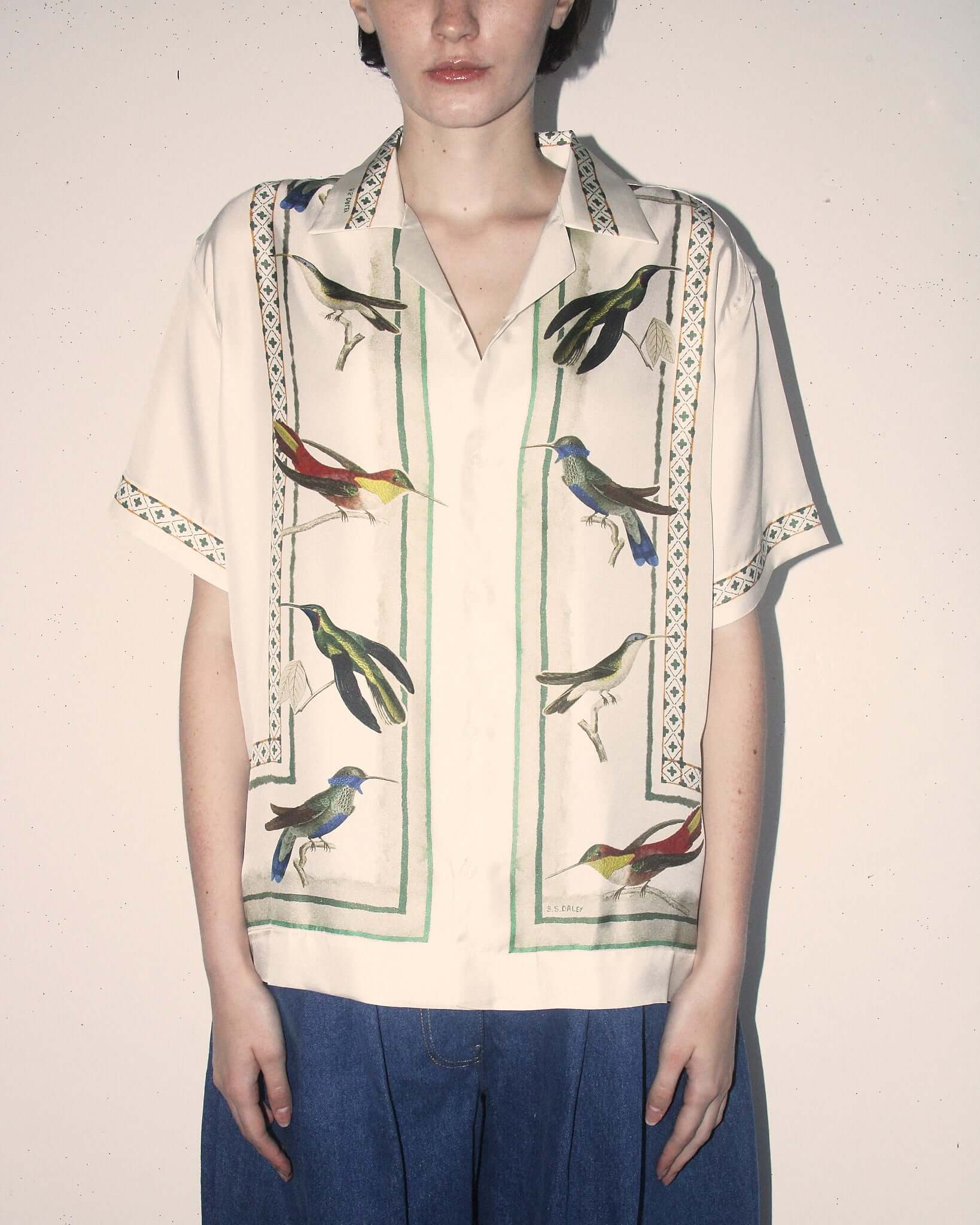 A detail shot of the 'Birdwatcher' shirt on a model, showing the garment buttoned up.
