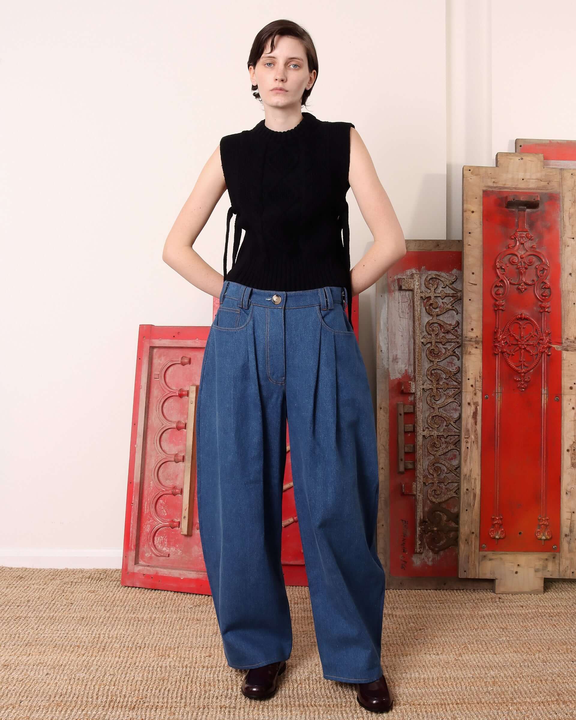 A model wears the black 'Blandine' Vest with the side-ties untied.