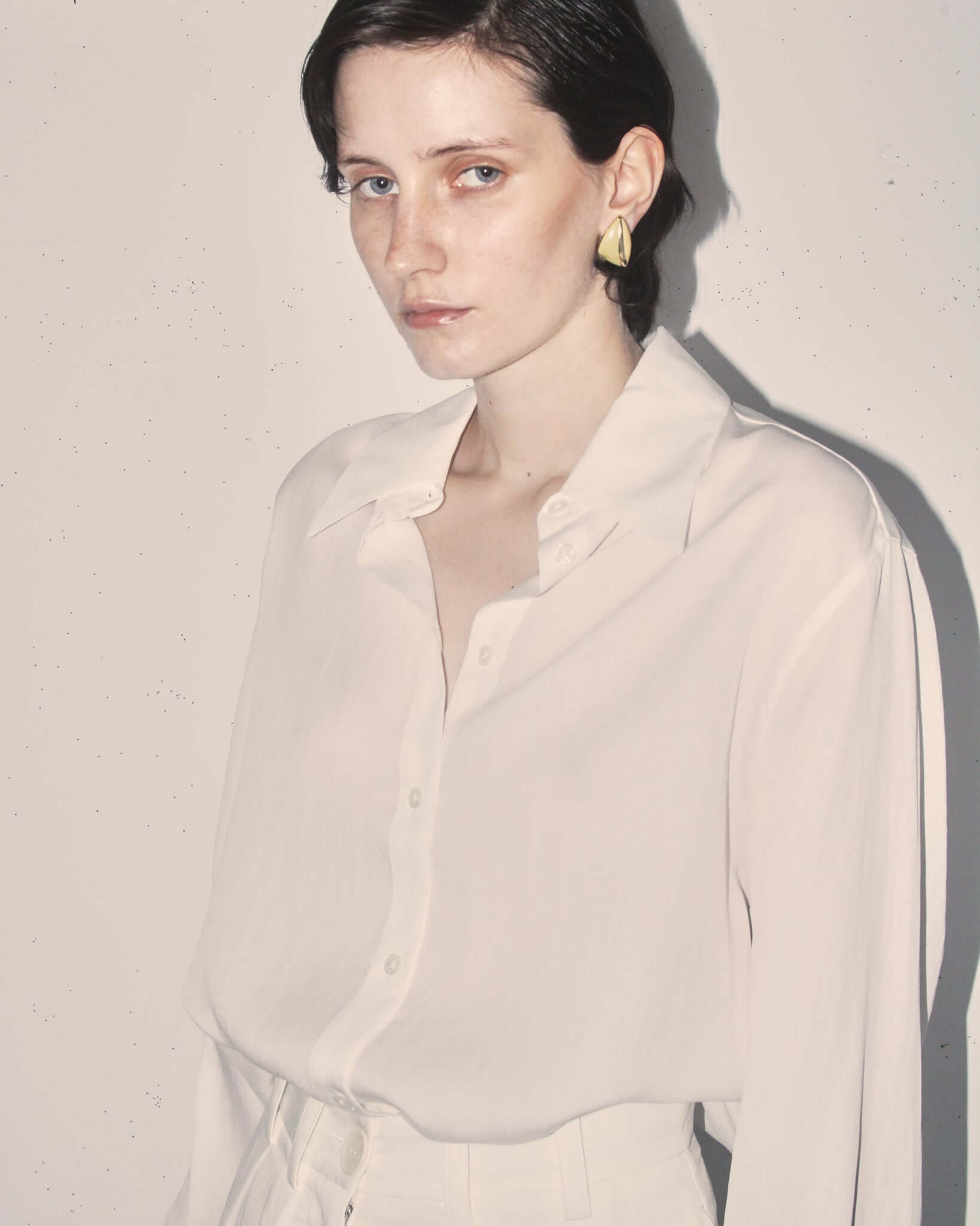 A close-up of a model wearing the 'Orla' Long Sleeved Shirt, showing the soft sandwashed silk and flowing sleeves.