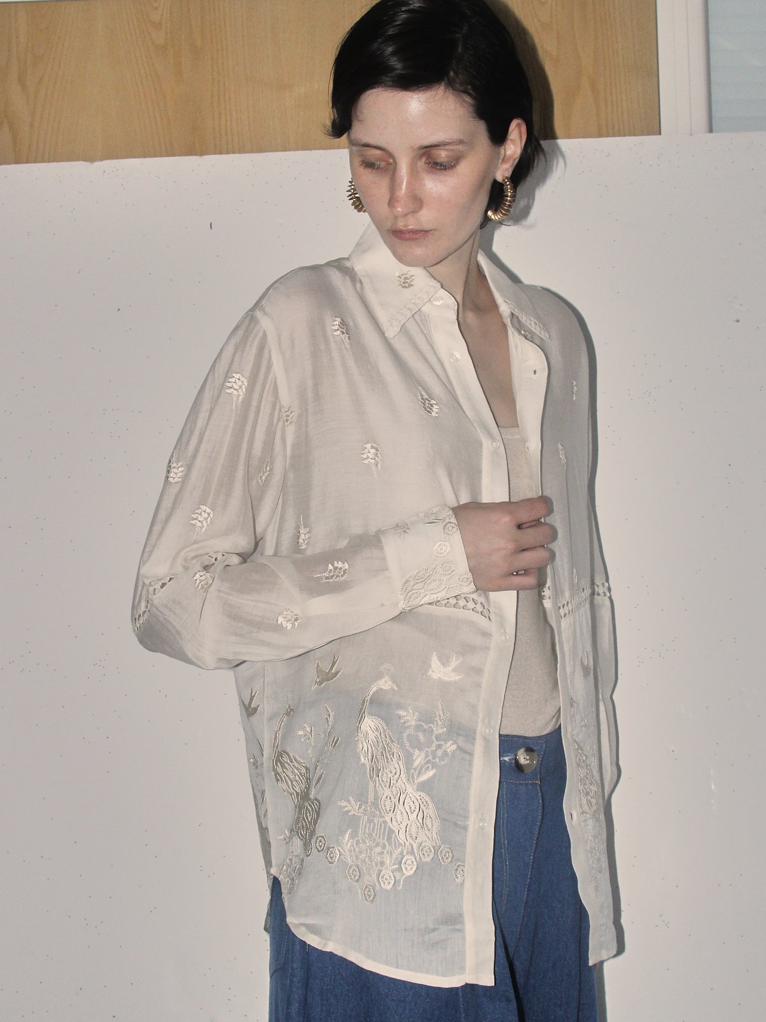 A detail shot of a model wearing the 'Ada' Long Sleeve Shirt in white.