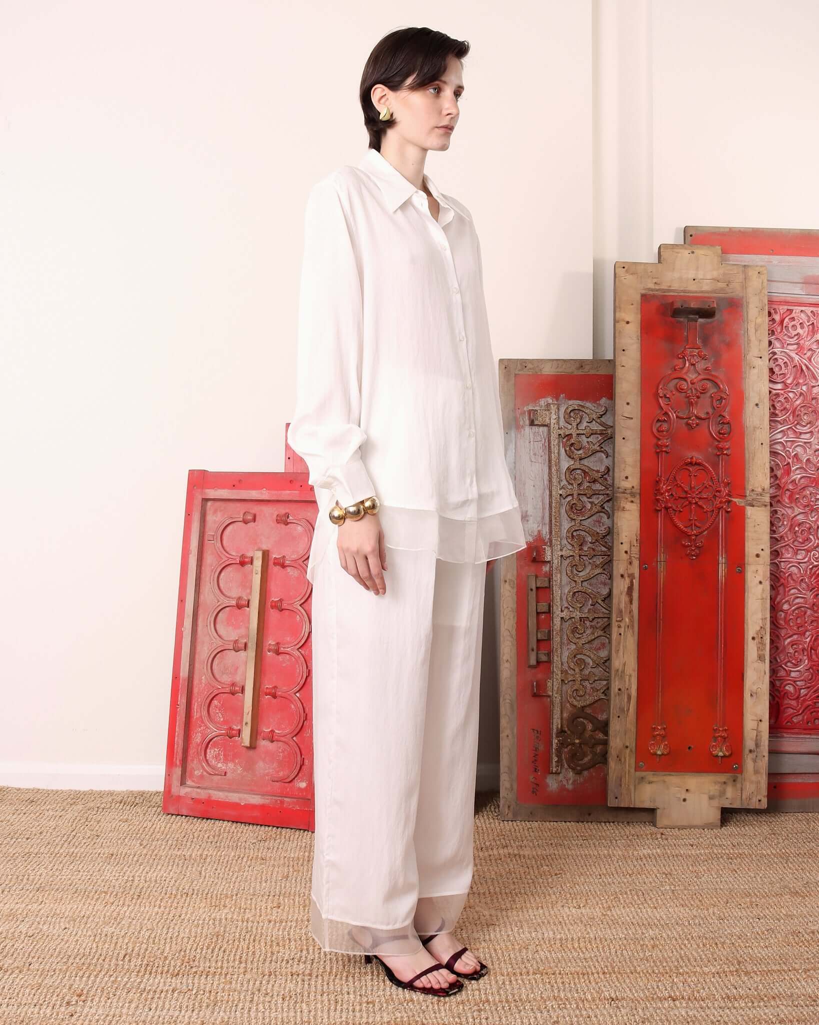 A model wears the long sleeve 'Orla' Shirt styled with the matching 'Orla' Trousers showing the matching  soft, organza hems.