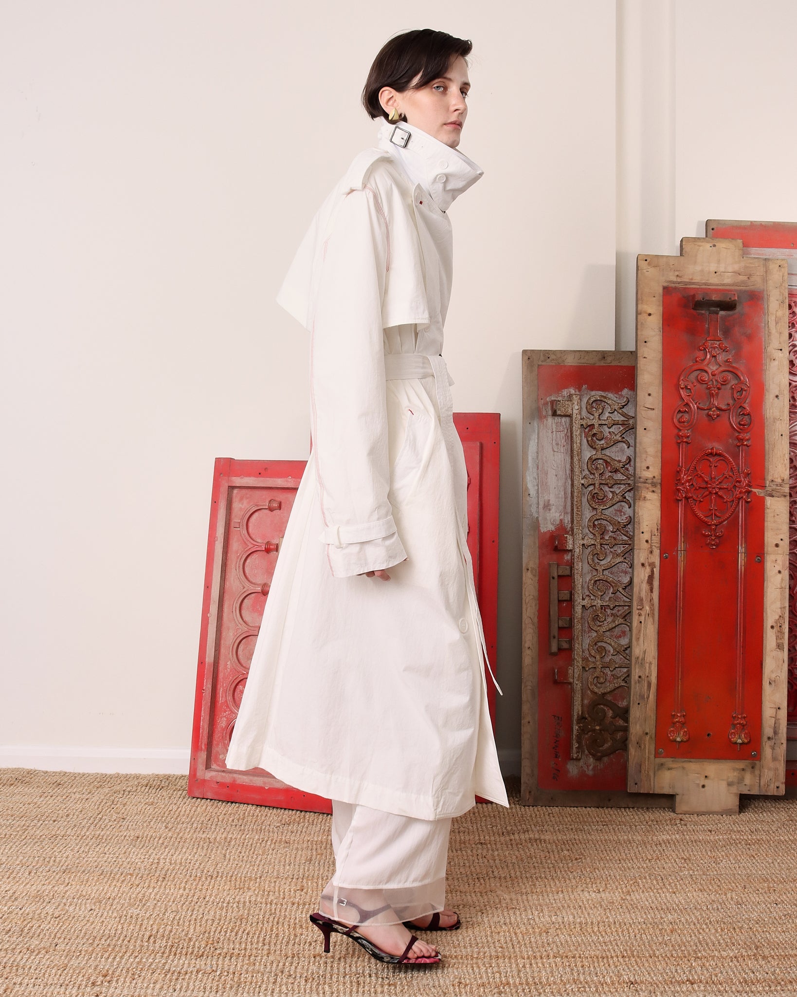 A model shows the side and sleeve of the 'Sophia' Trench in white. 