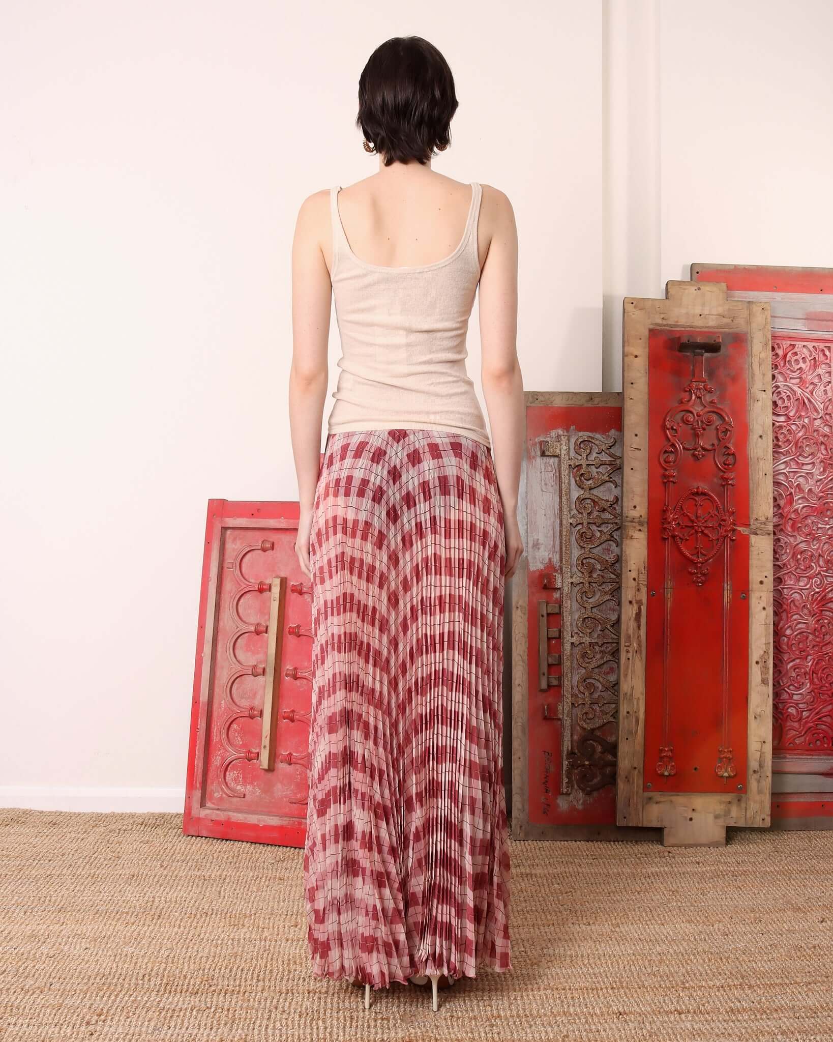 A model shows the back of the floor-length 'Kate' Skirt in pink argyle print.