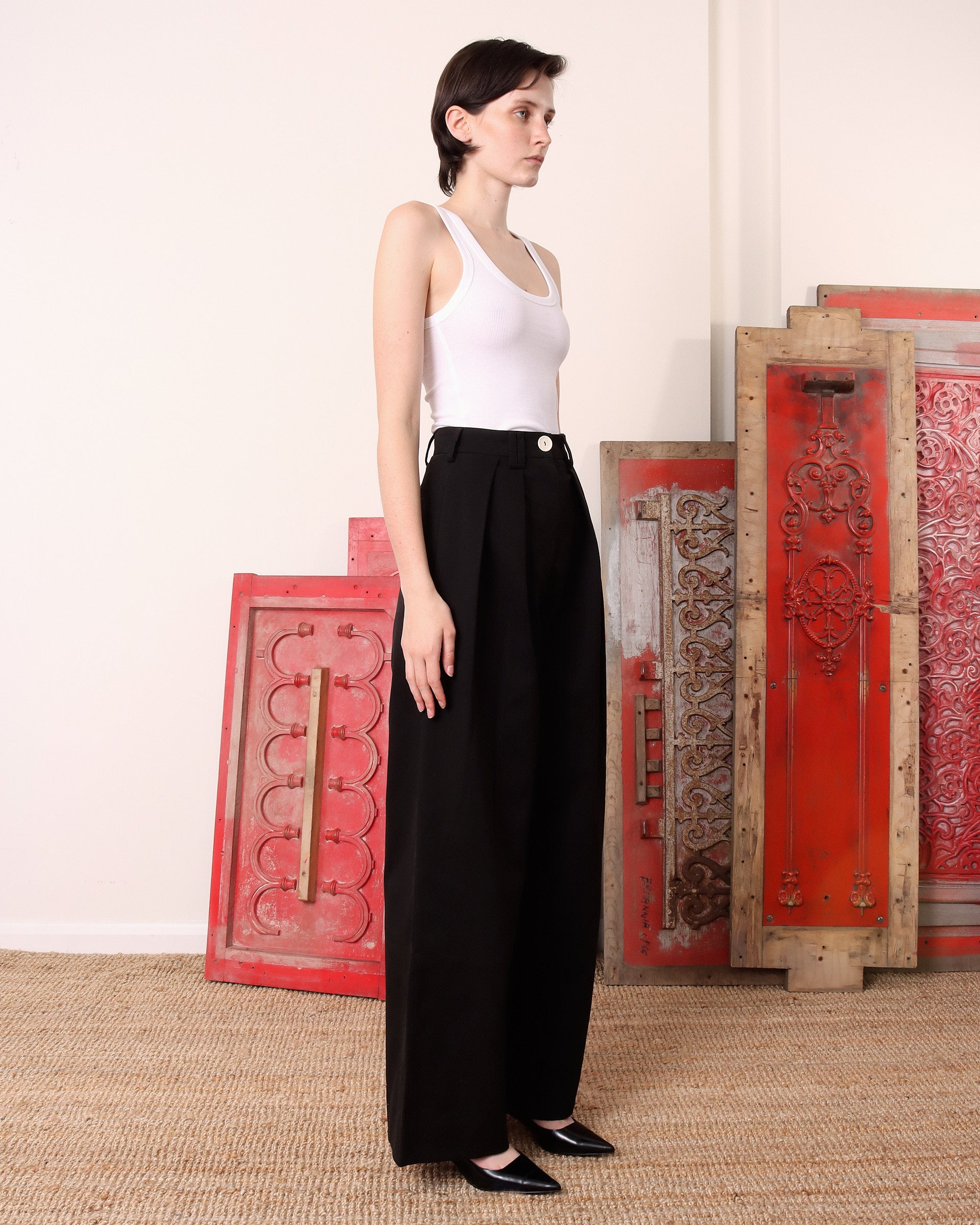 A model shows the side of the 'Georgina' Trousers in black.