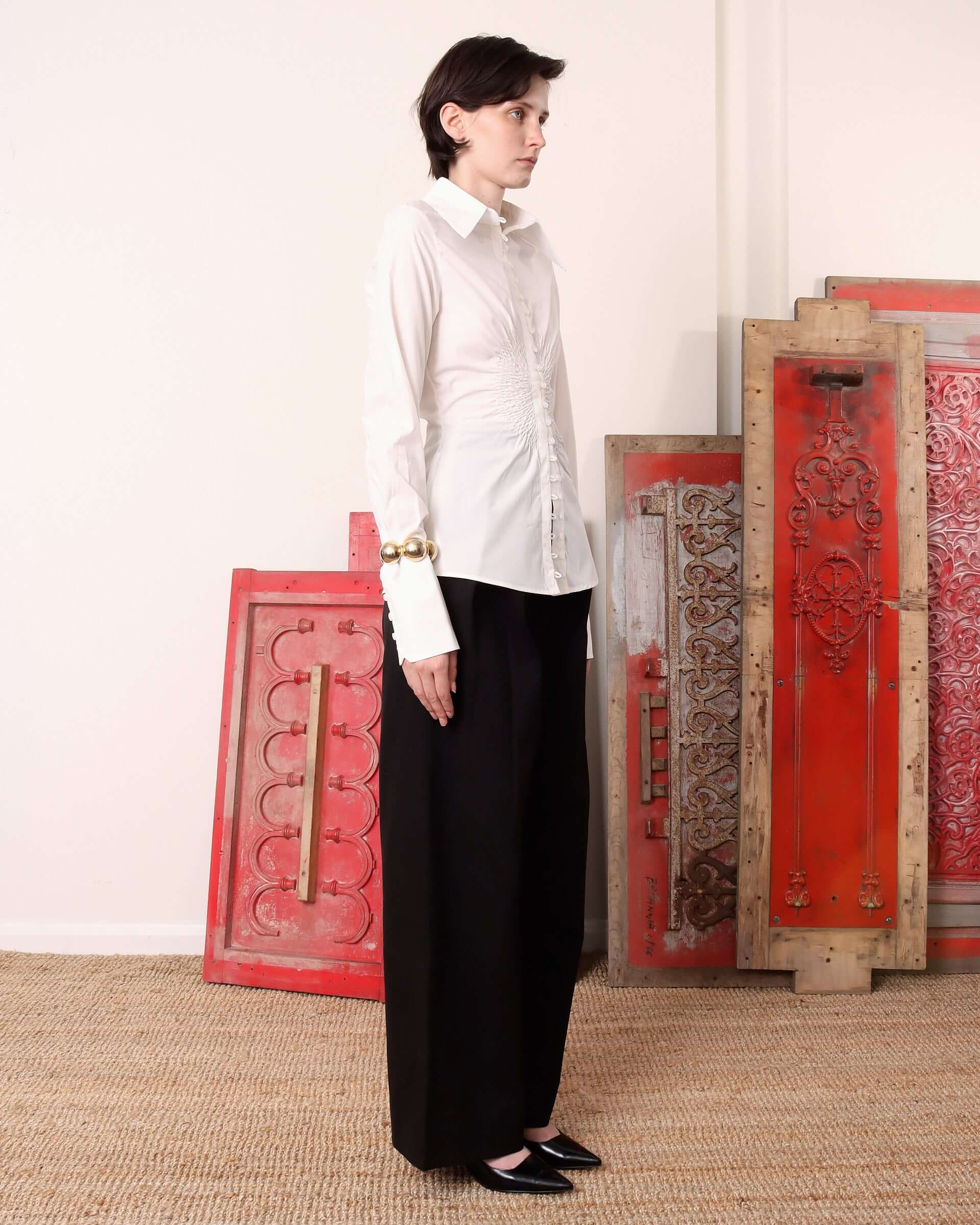 A model shows the side of the 'Eva' Circle Shirt in white.