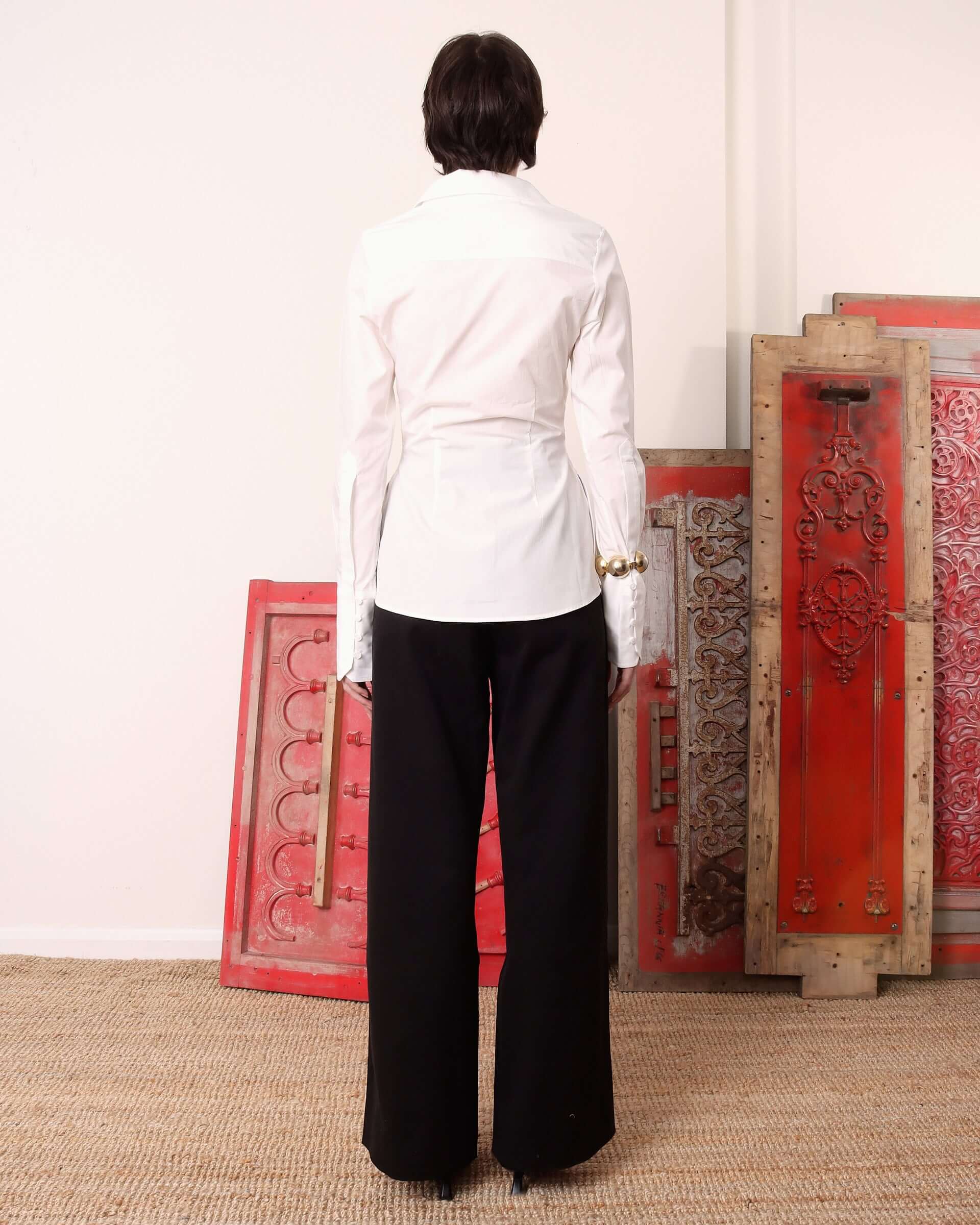 A model shows the waist cinching back of the 'Eva' Circle Shirt in white.