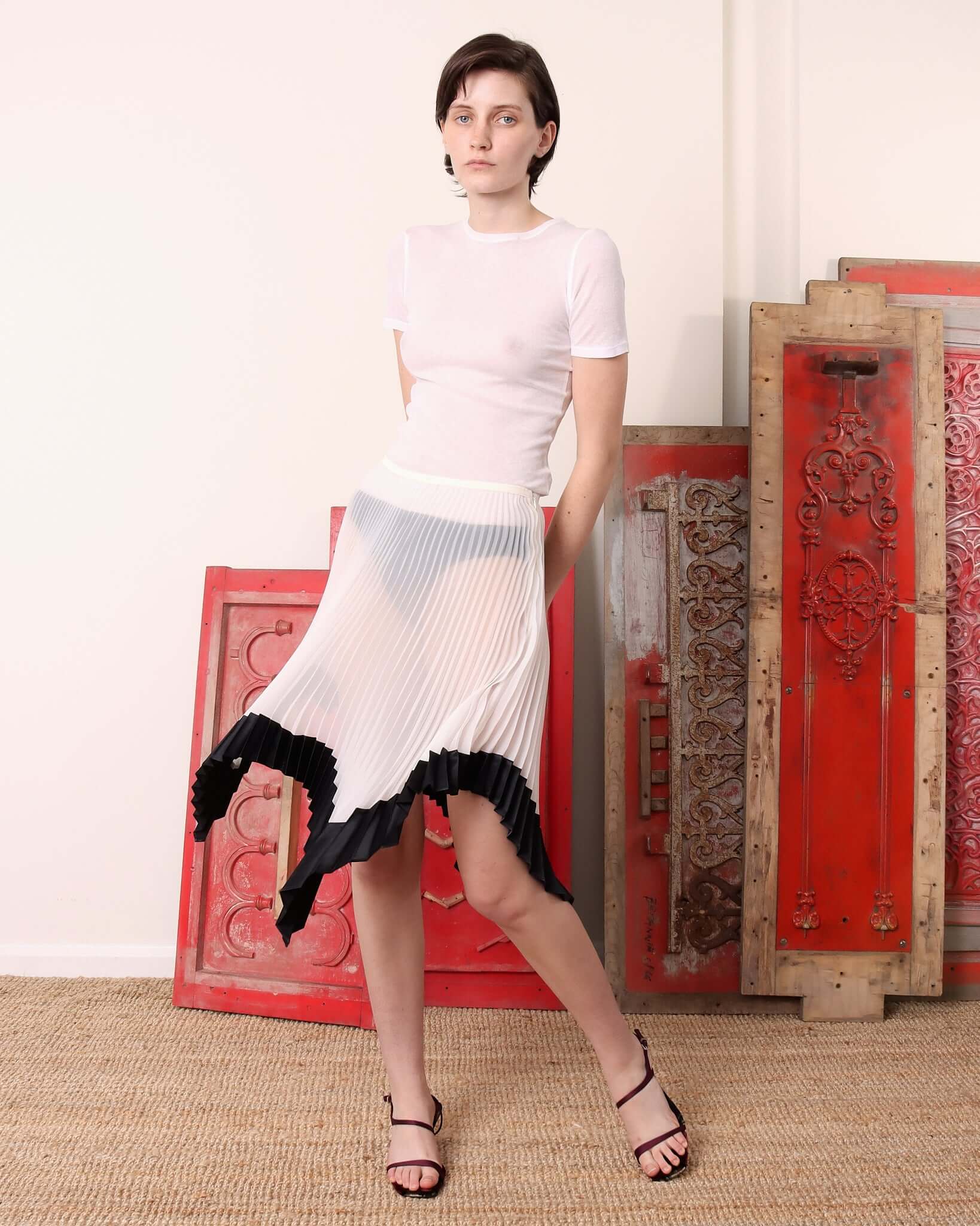 A model wears the 'Mia' Skirt showing the flowing movement of the sun-ray pleats.