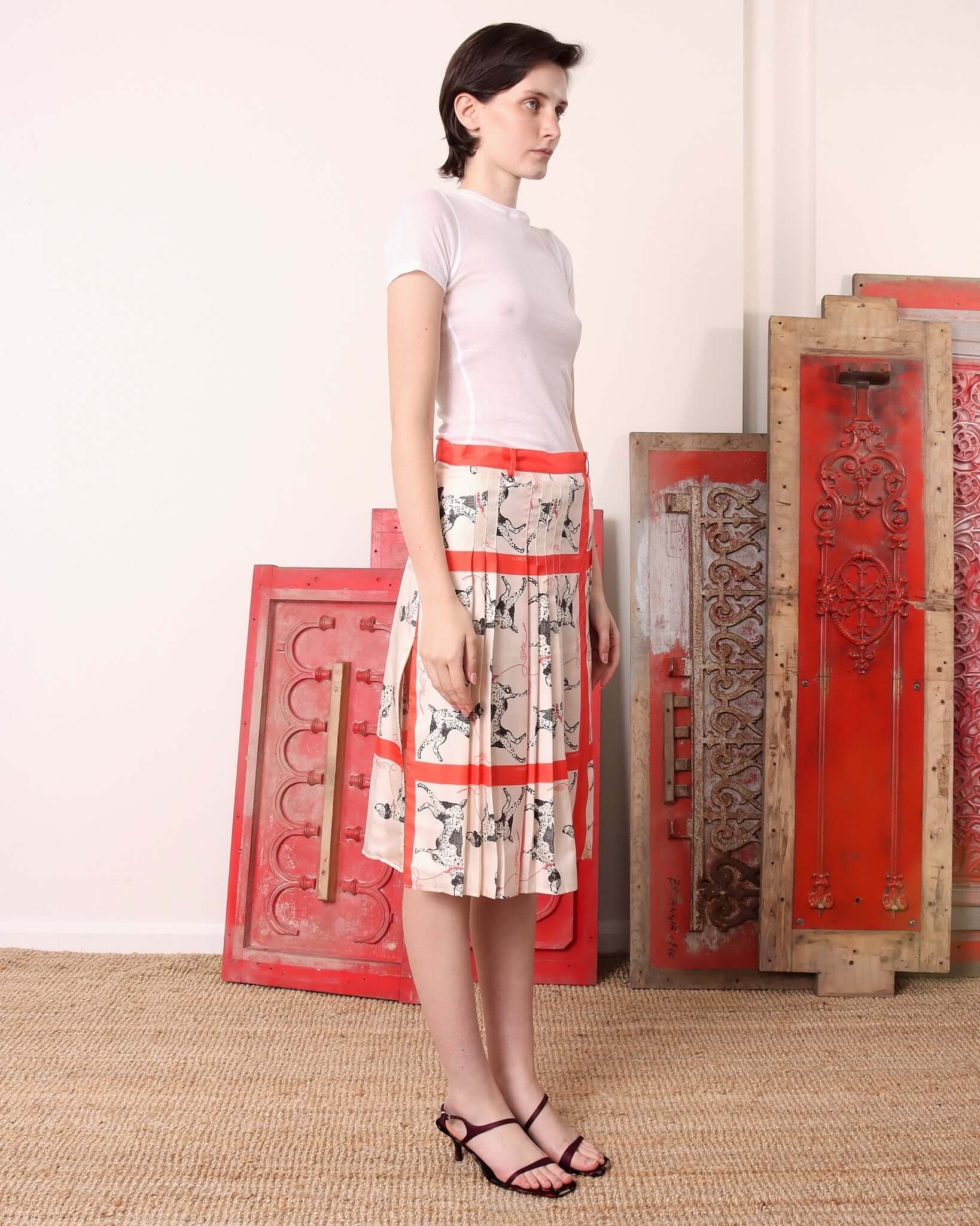 A model shows the side of the 'Pointer' Skirt and pleated design.