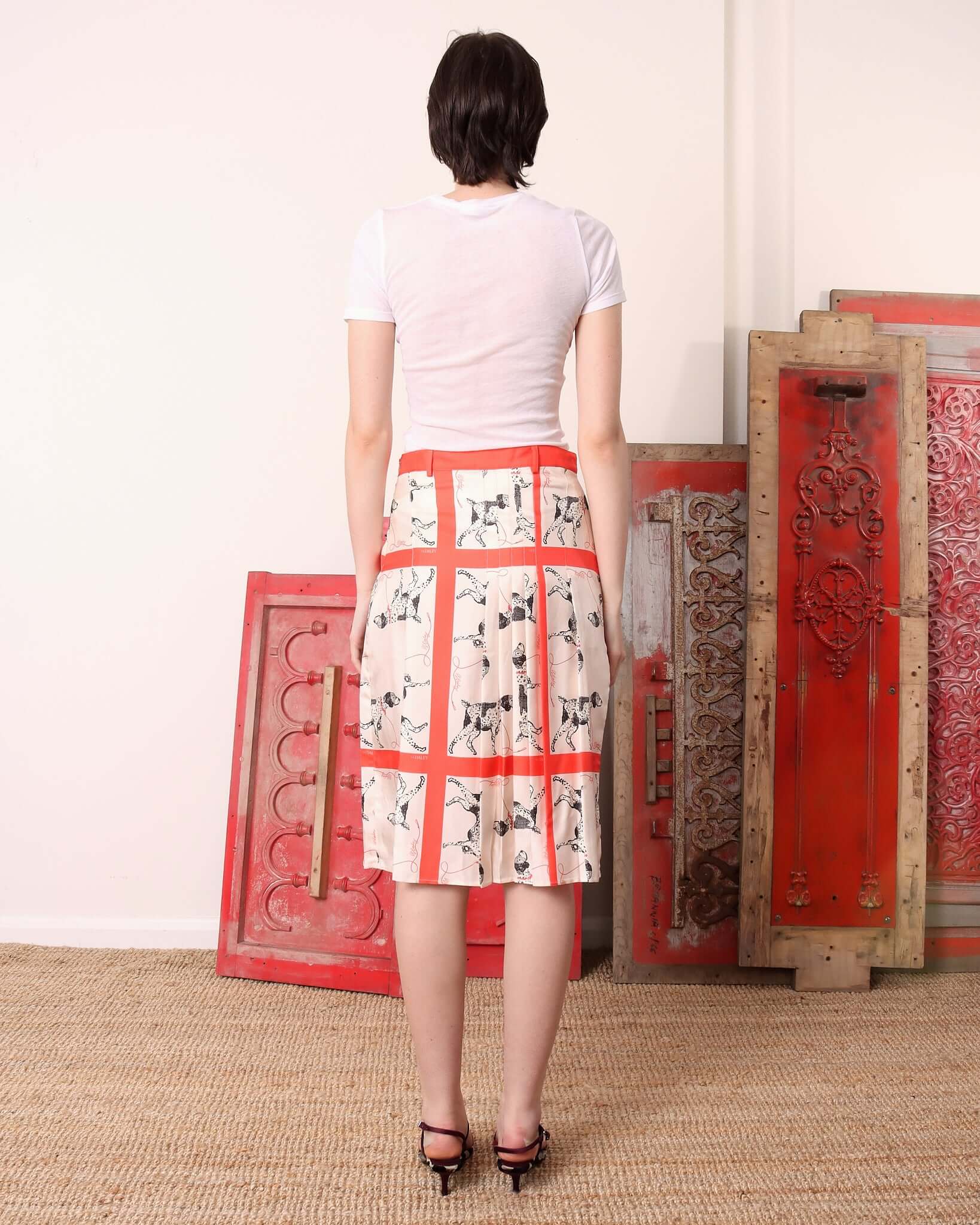 A model shows the back of the printed 'Pointer' Skirt in silk.