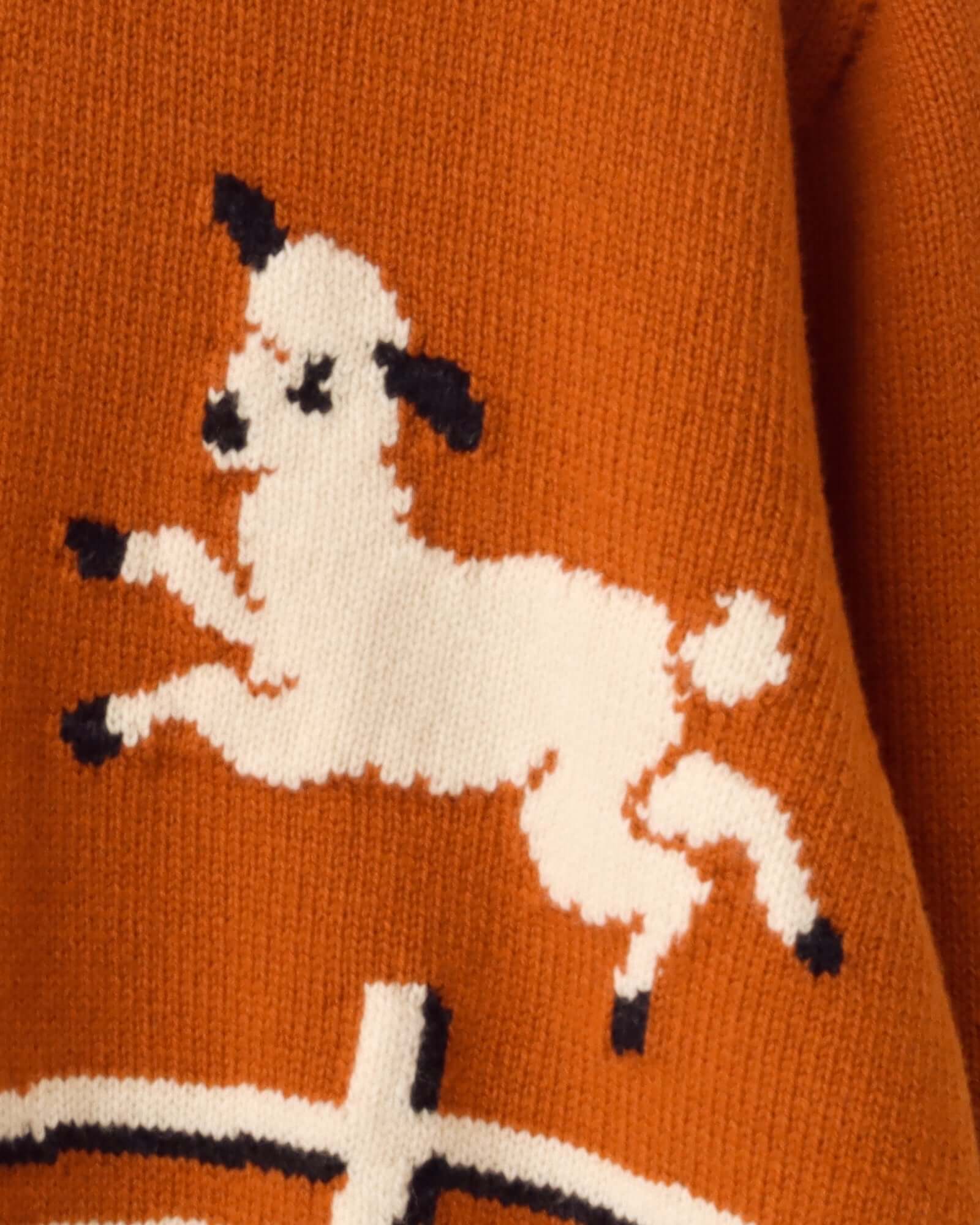A detail shot of  one of the lamb motifs on the 'Cyril' Lamb Cardigan in tawny.