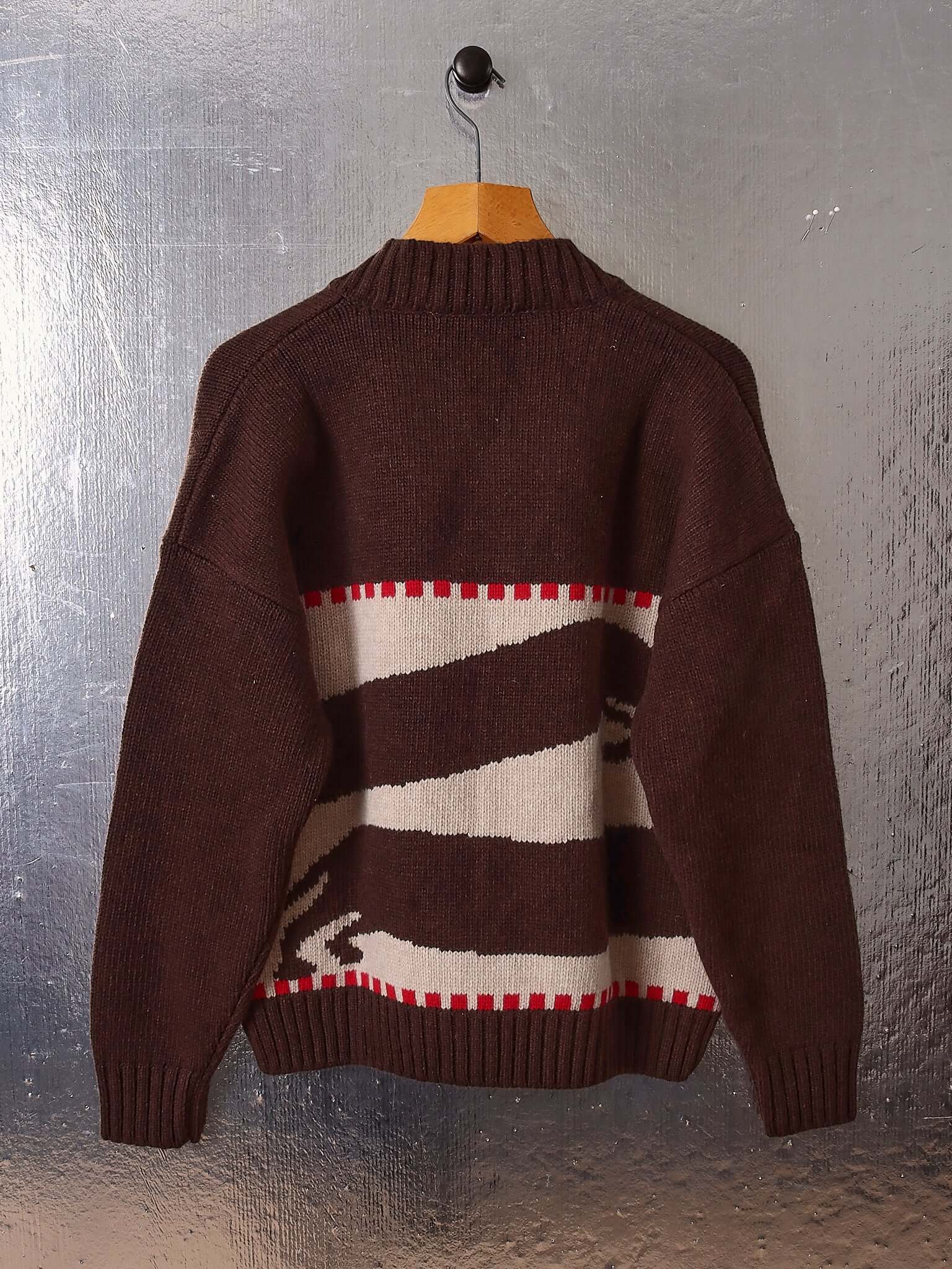 A flat image shows the back of the 'Harold' V-Neck Sweater Vest in brown and ecru and the two dachshund motifs.