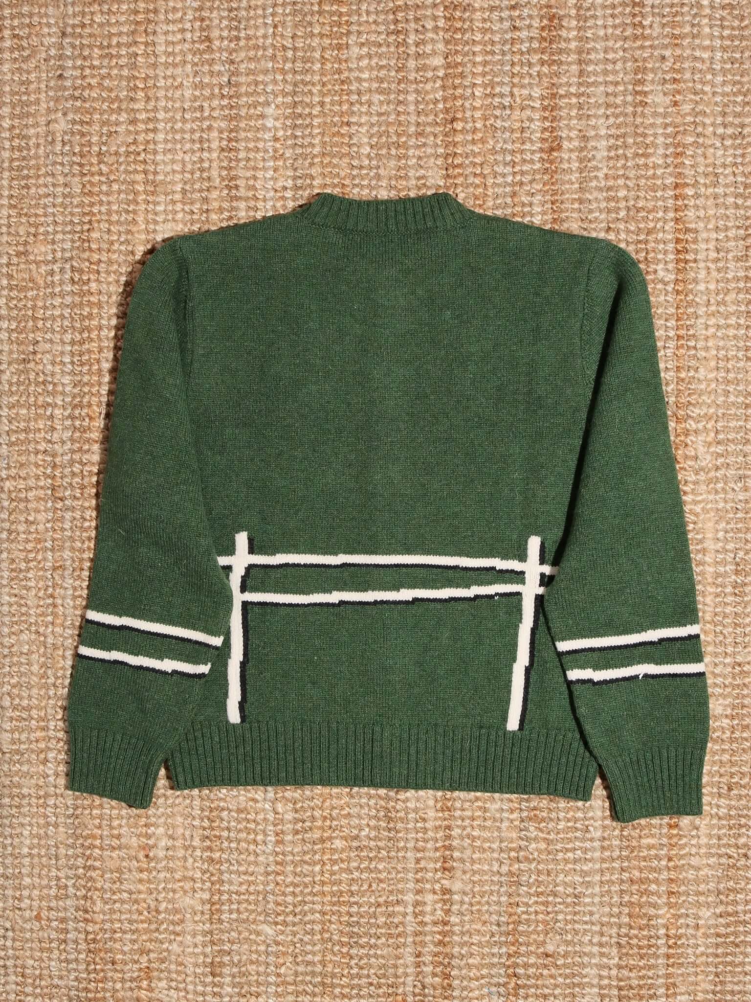 A flat shot of the back of the 'Cyril' Lamb Motif Cardigan in green.