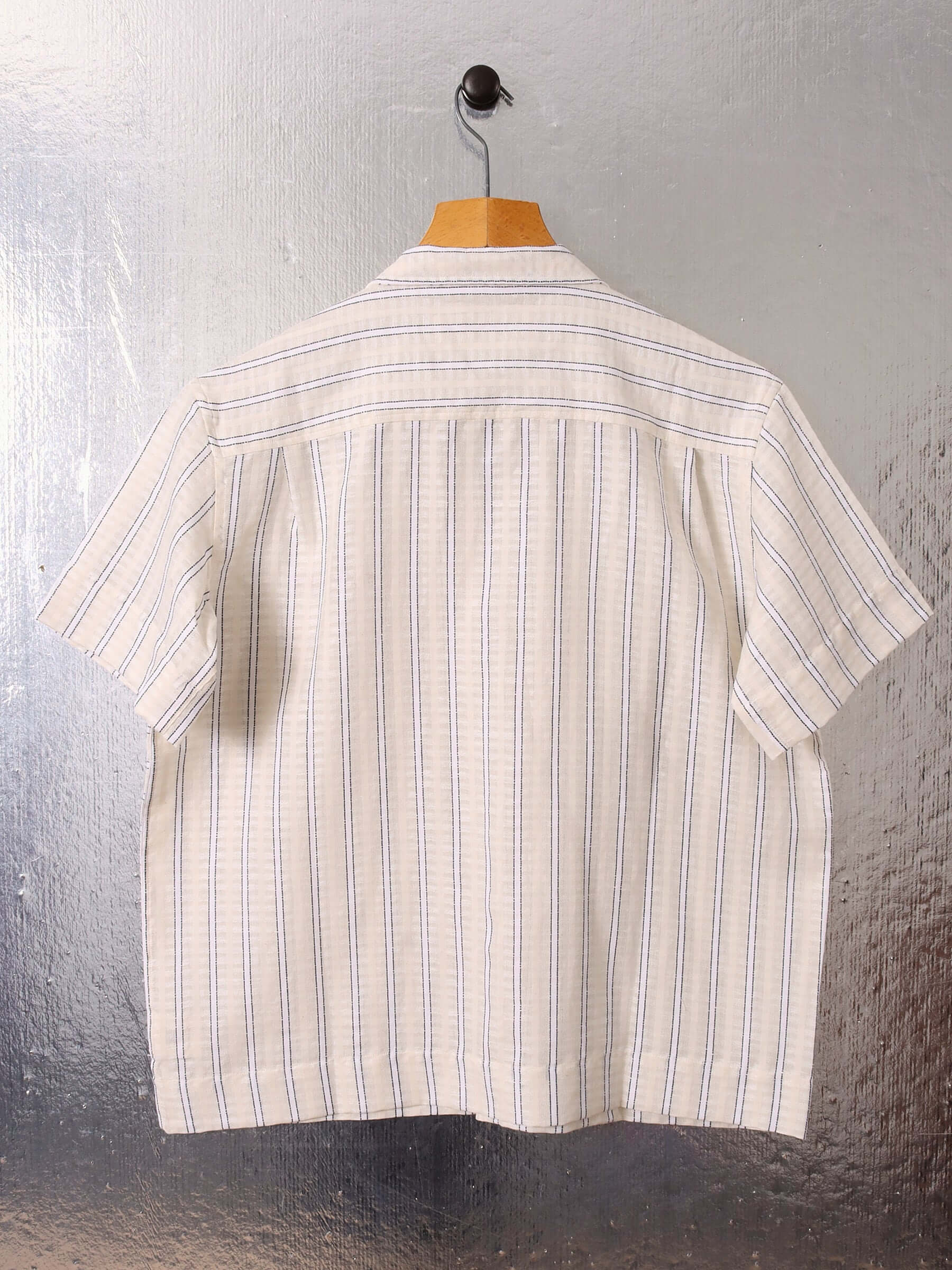 A flat image of the striped 'Turing' Shirt with short sleeves, showing the back and it's relaxed, boxy fit.