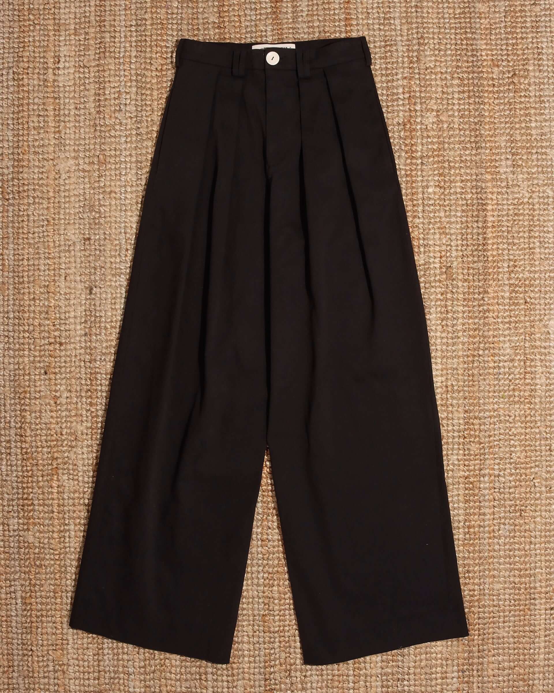 A flat image of the 'George' Trouser in black with a white button.
