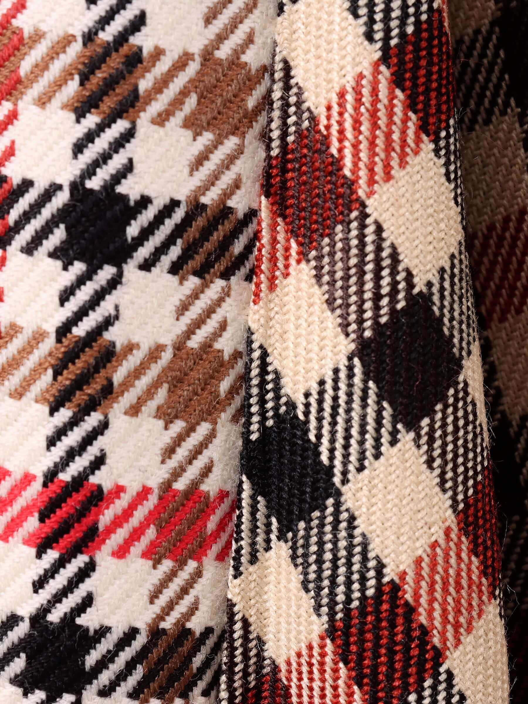 A close-up shot of the brown, red, black, and ecru check pattern of the 'Taali' Skirt in Check.