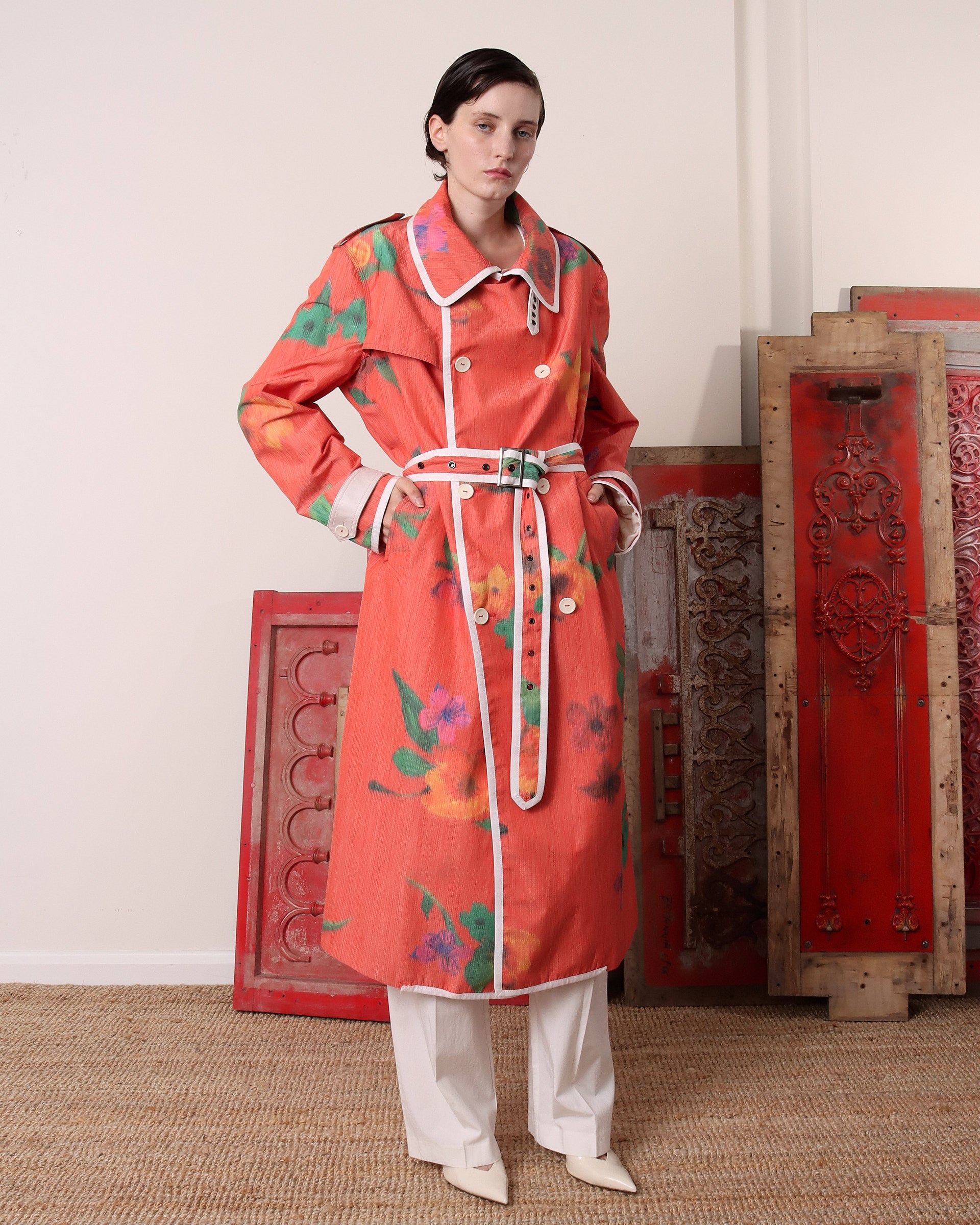 A model wears the 'Sophia Trench in floral buttoned to the collar.