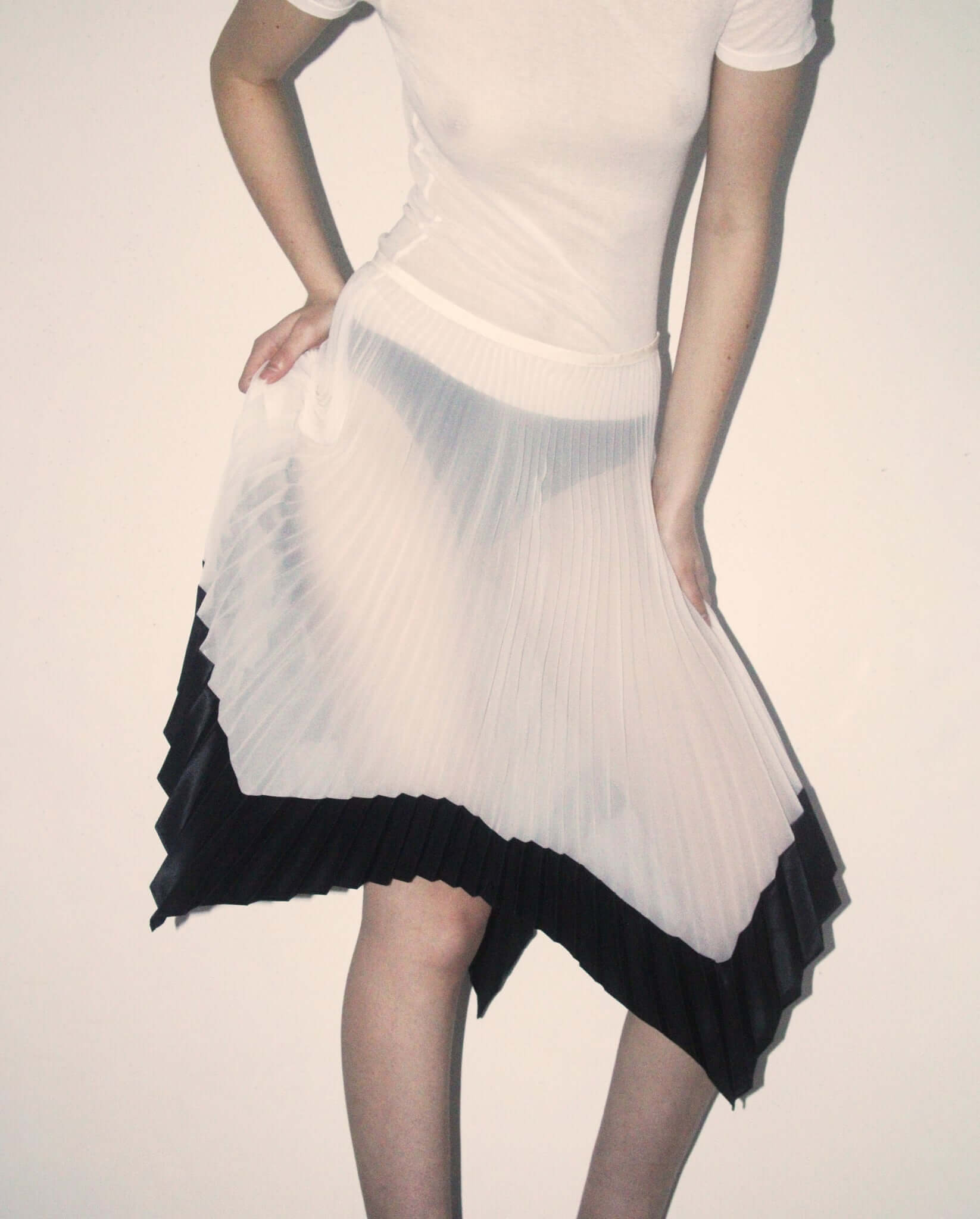 A detail shot of the 'Mia' Skirt in mid-length showing the movement.